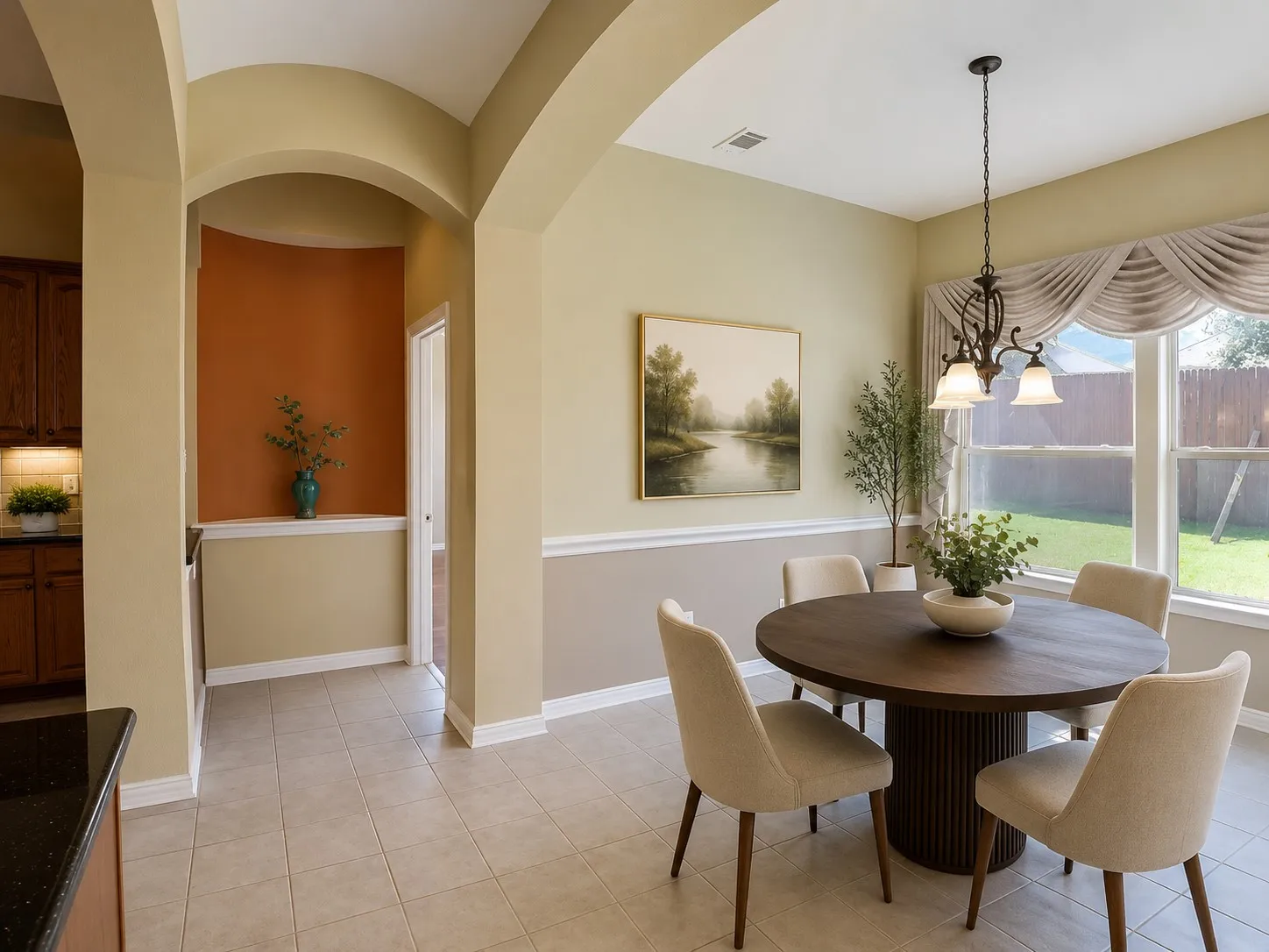 Dining area featuring tile flooring, a window with backyard views, and a decorative chandelier