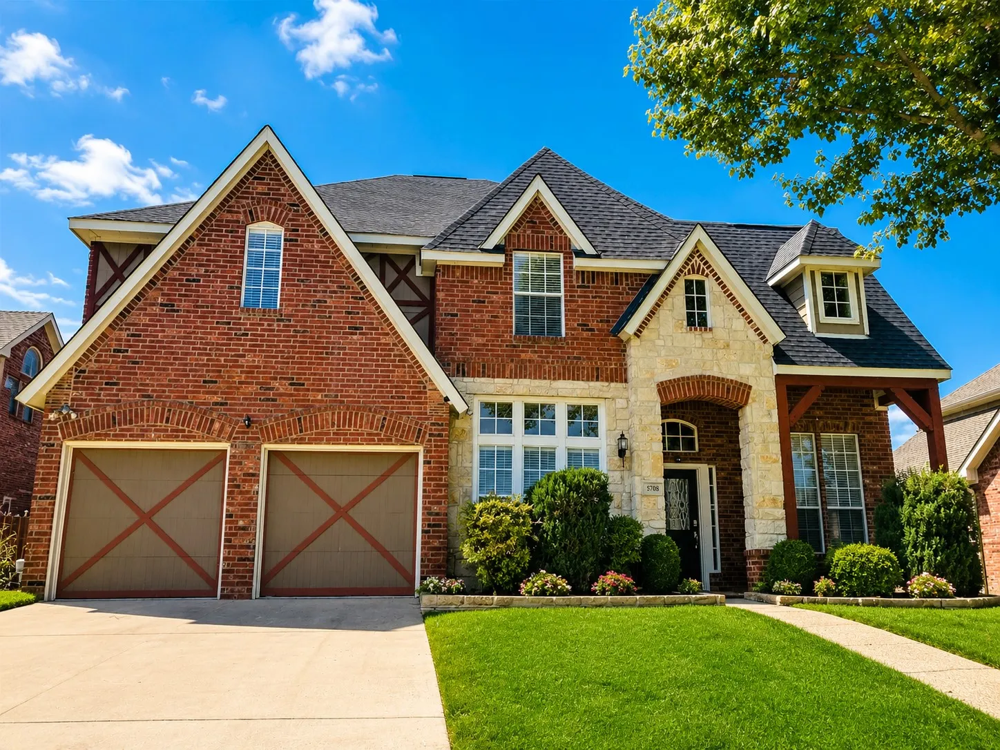 Brick and stone facade featuring gabled rooflines