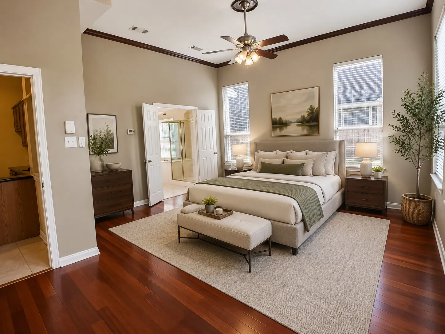 Spacious room featuring hardwood flooring, vaulted ceiling, and crown molding