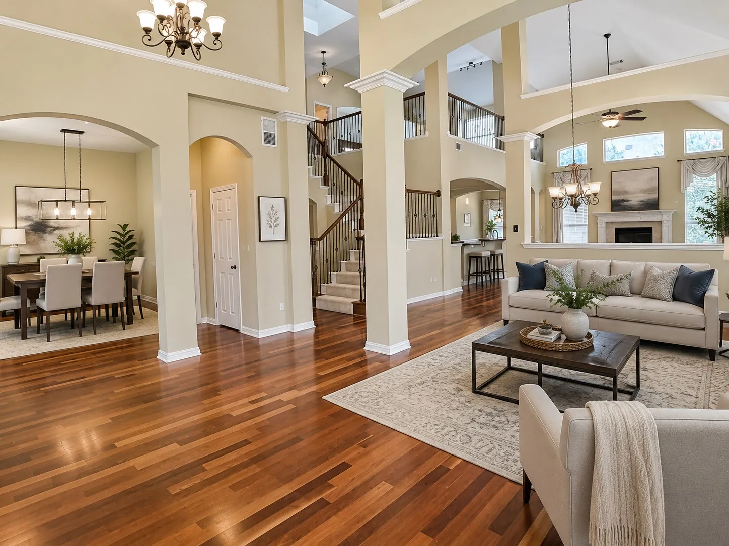 Spacious interior featuring wood-finish flooring, vaulted ceilings, and an arched entryway