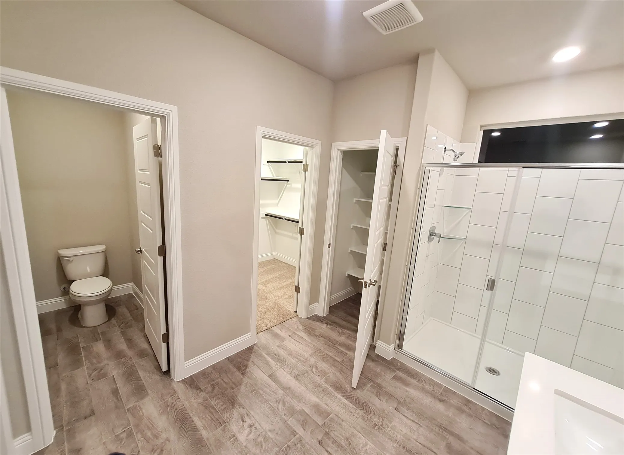 Another view of Master Bath with toilet and master walk-in-closet.