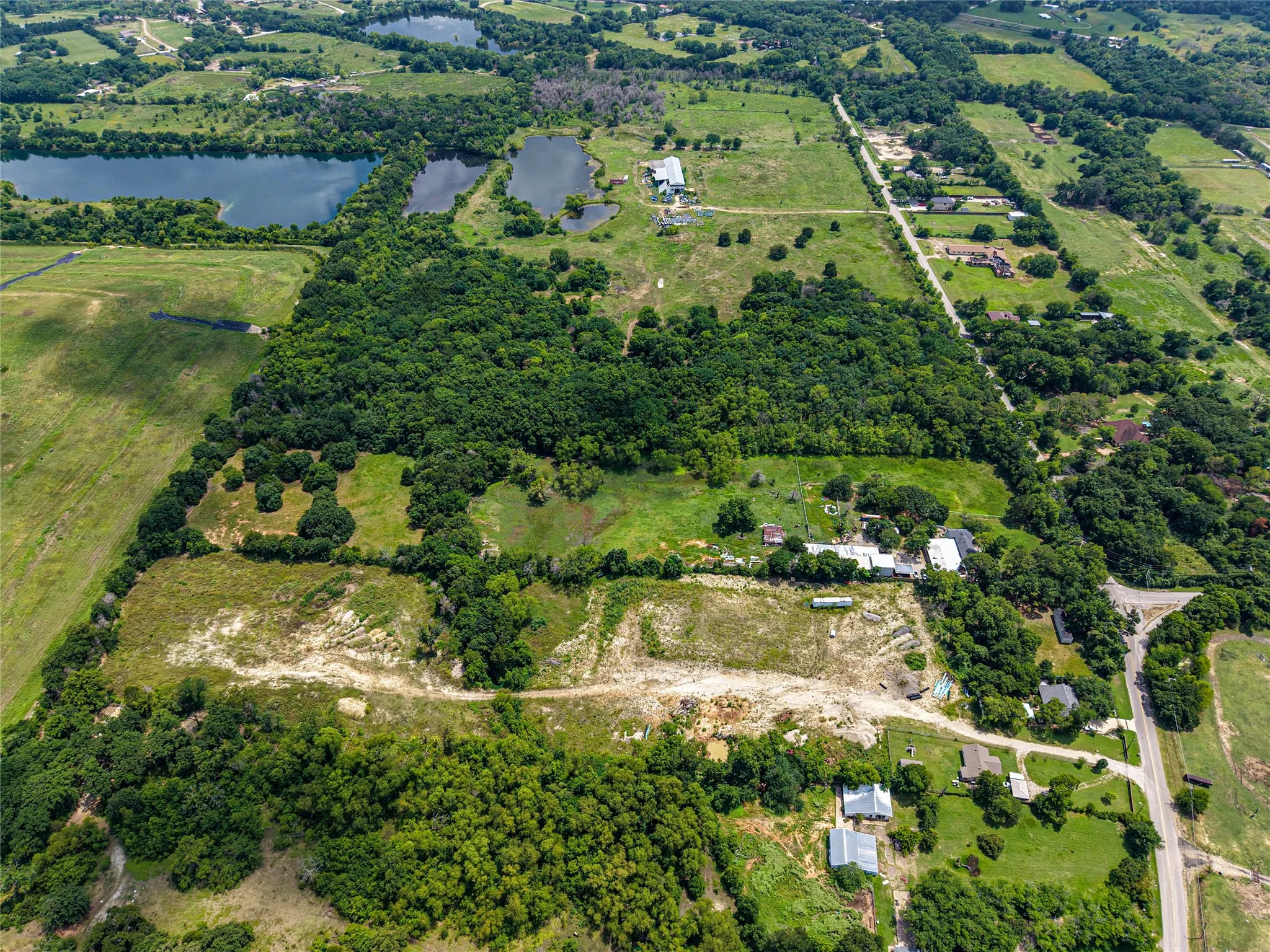 Expansive aerial perspective showcasing diverse terrain with significant tree coverage