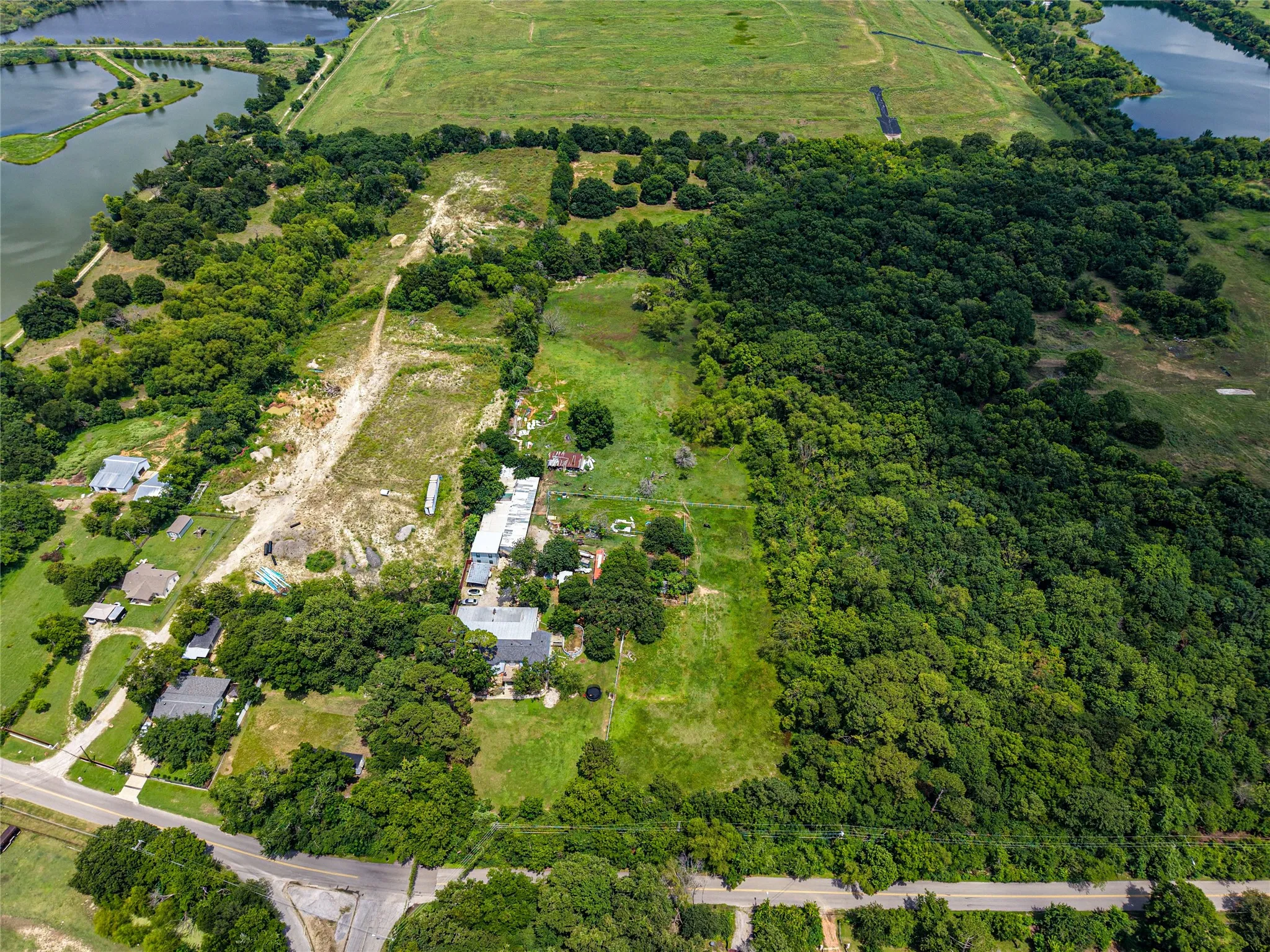 Expansive acreage featuring abundant mature trees, multiple clearings, and a substantial wooded area