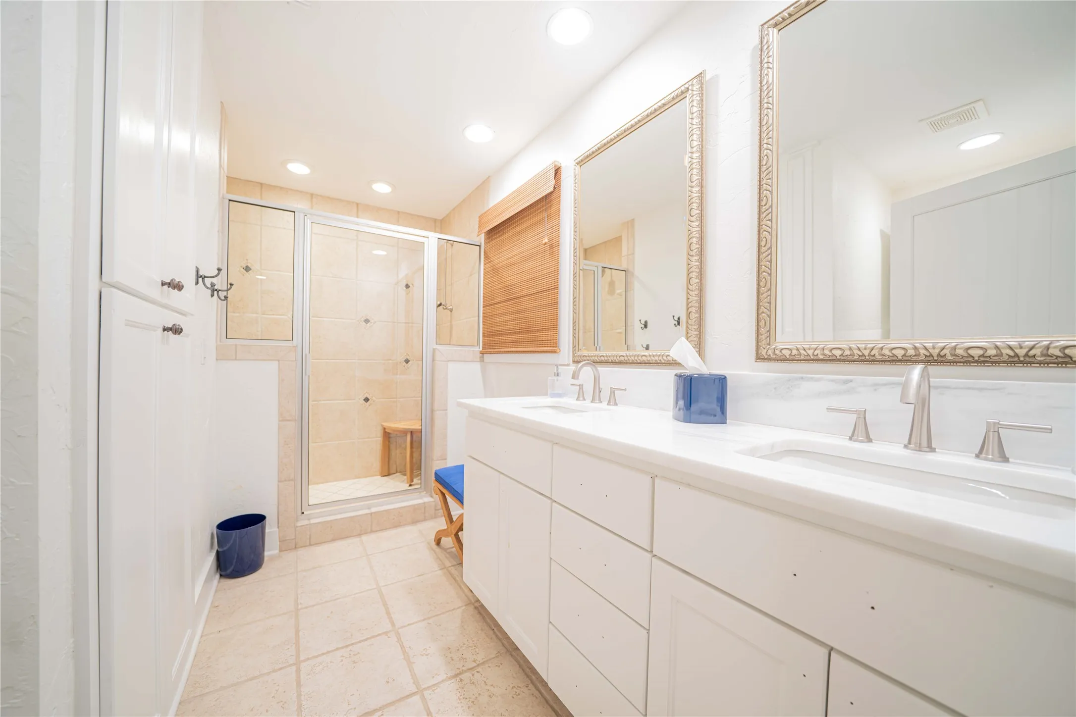Full bath with a stall shower, double vanity, recessed lighting, and tile patterned floors