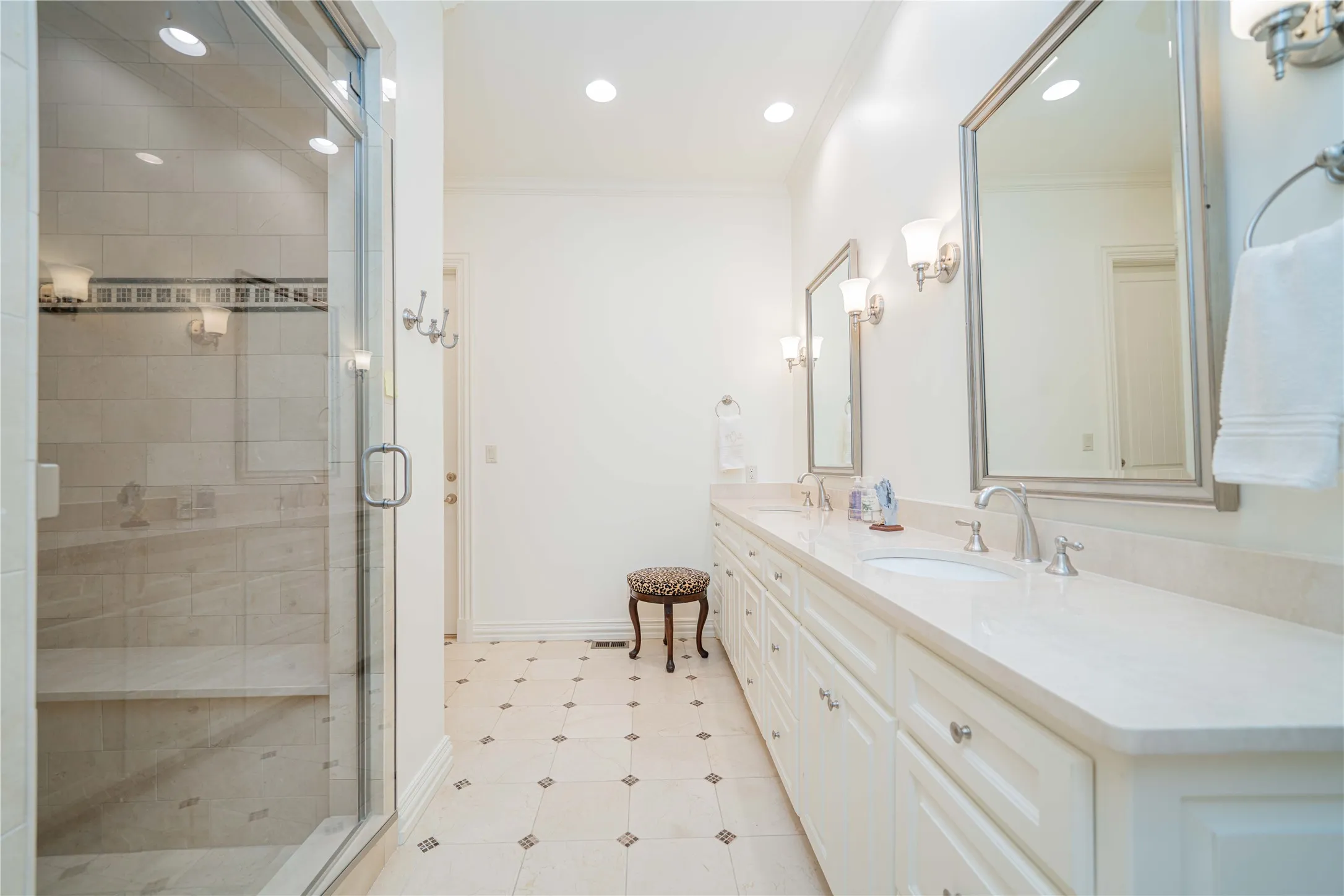 Bathroom featuring double vanity, a shower stall, ornamental molding, recessed lighting, and tile patterned flooring