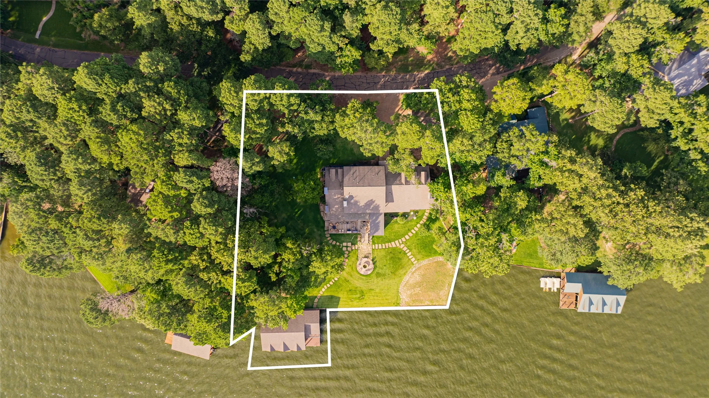 Aerial view of property and surrounding area with property parcel outlined
