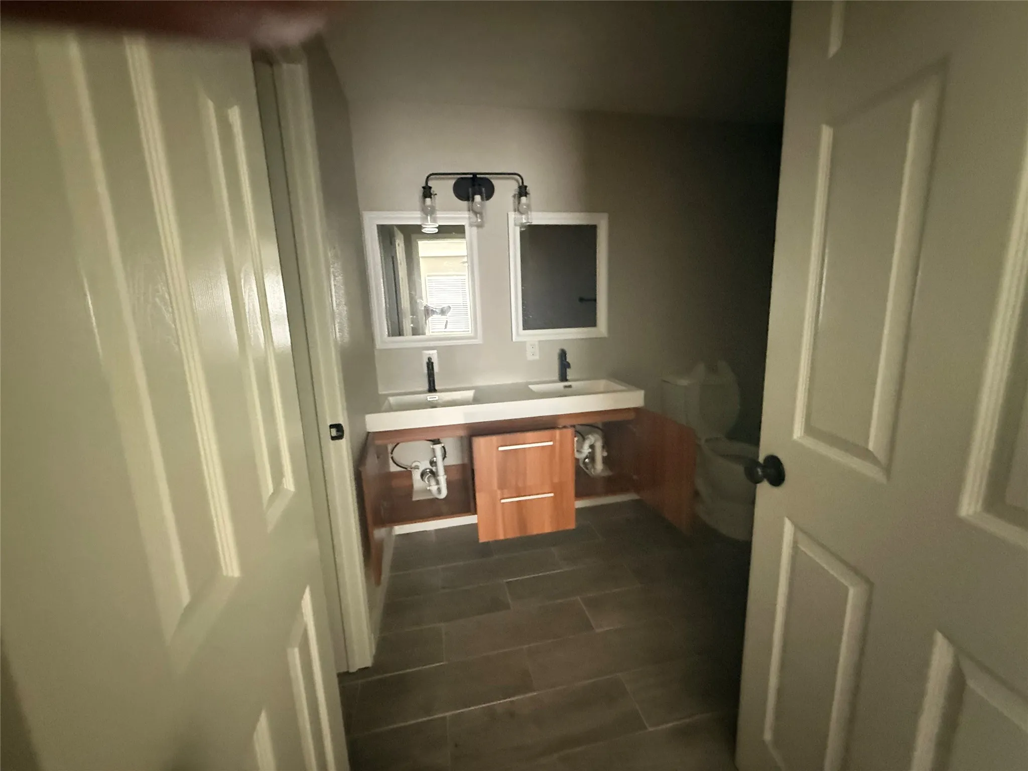 Dual sink vanity with wood-finish cabinetry and rectangular vessel sinks