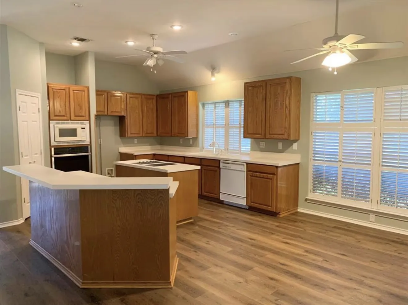 Kitchen featuring wood-finish flooring, recessed lighting, and ceiling fans