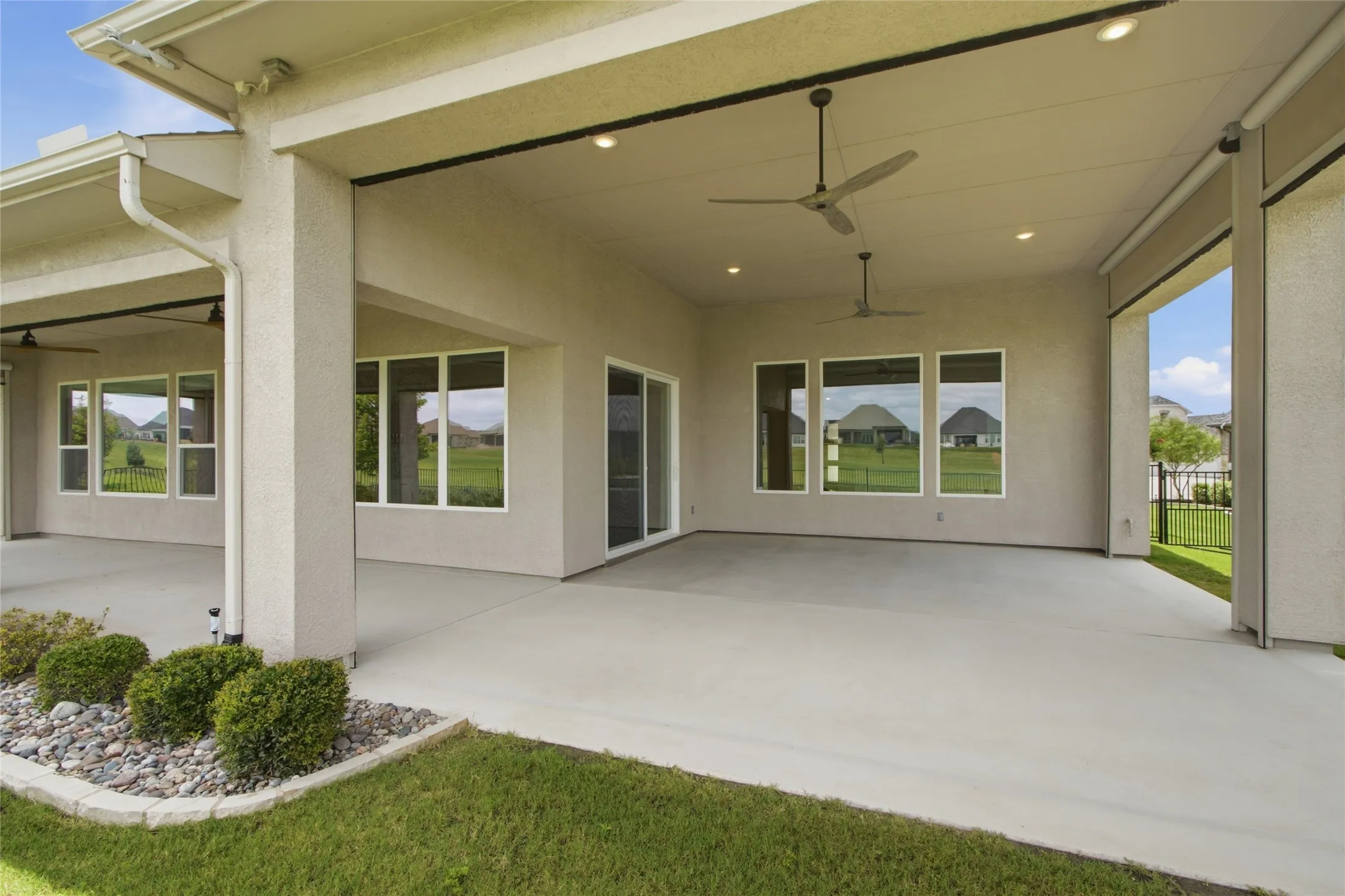 Covered patio has remote controlled screens for full protection from insects and flying golf balls!