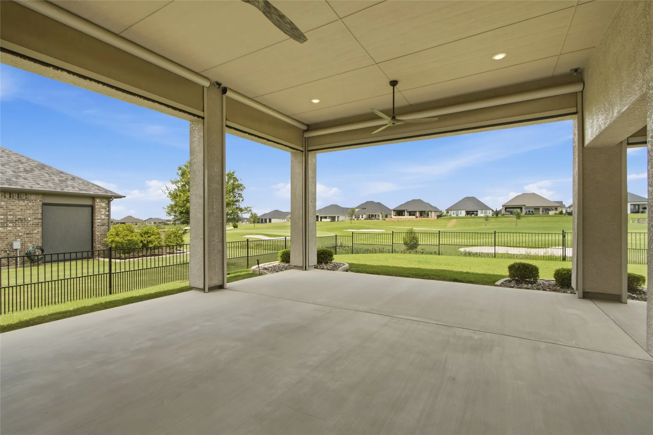 Spacious covered patio with recessed lighting and dual ceiling fans