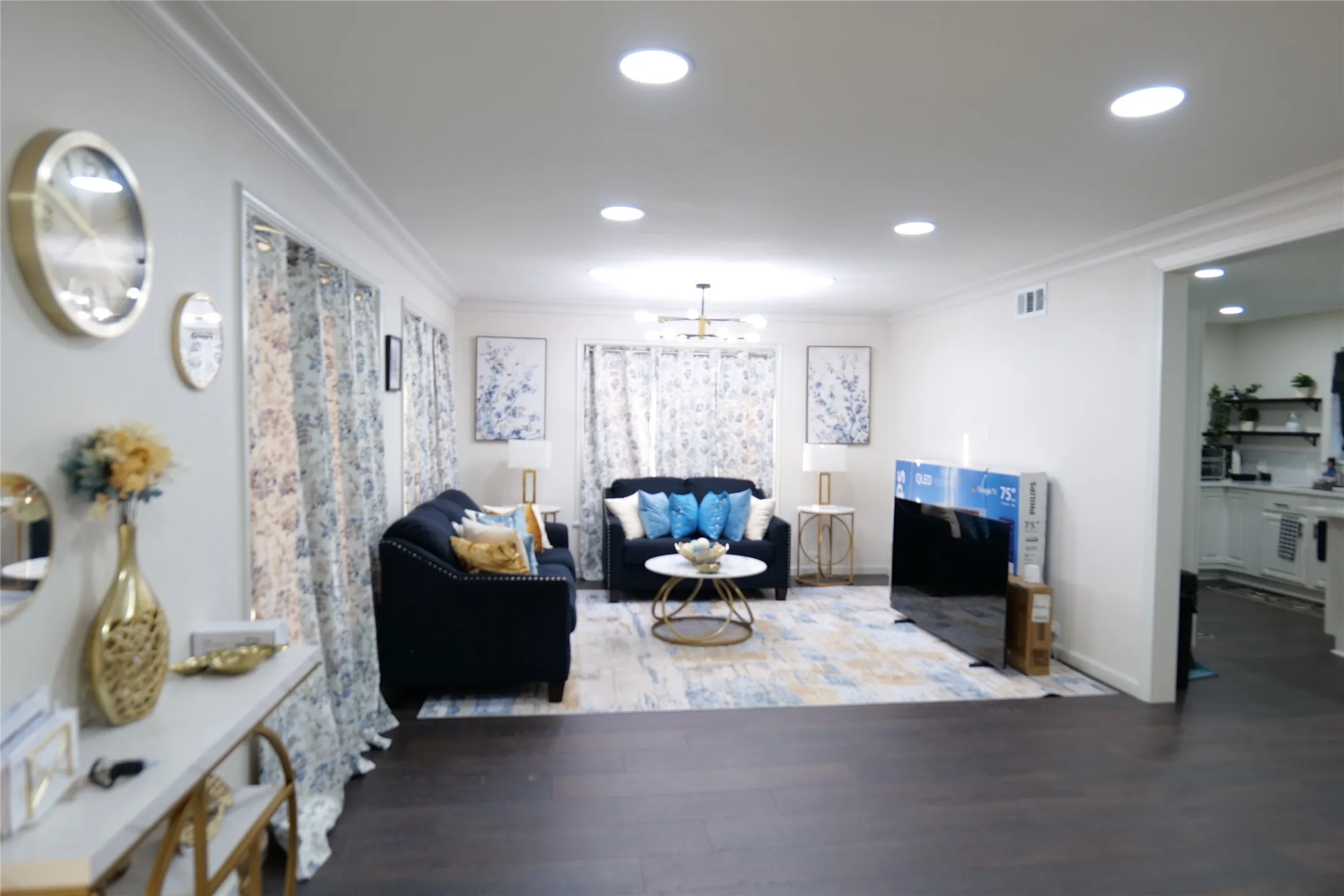 Spacious interior featuring dark wood-finish flooring, recessed lighting, and crown molding
