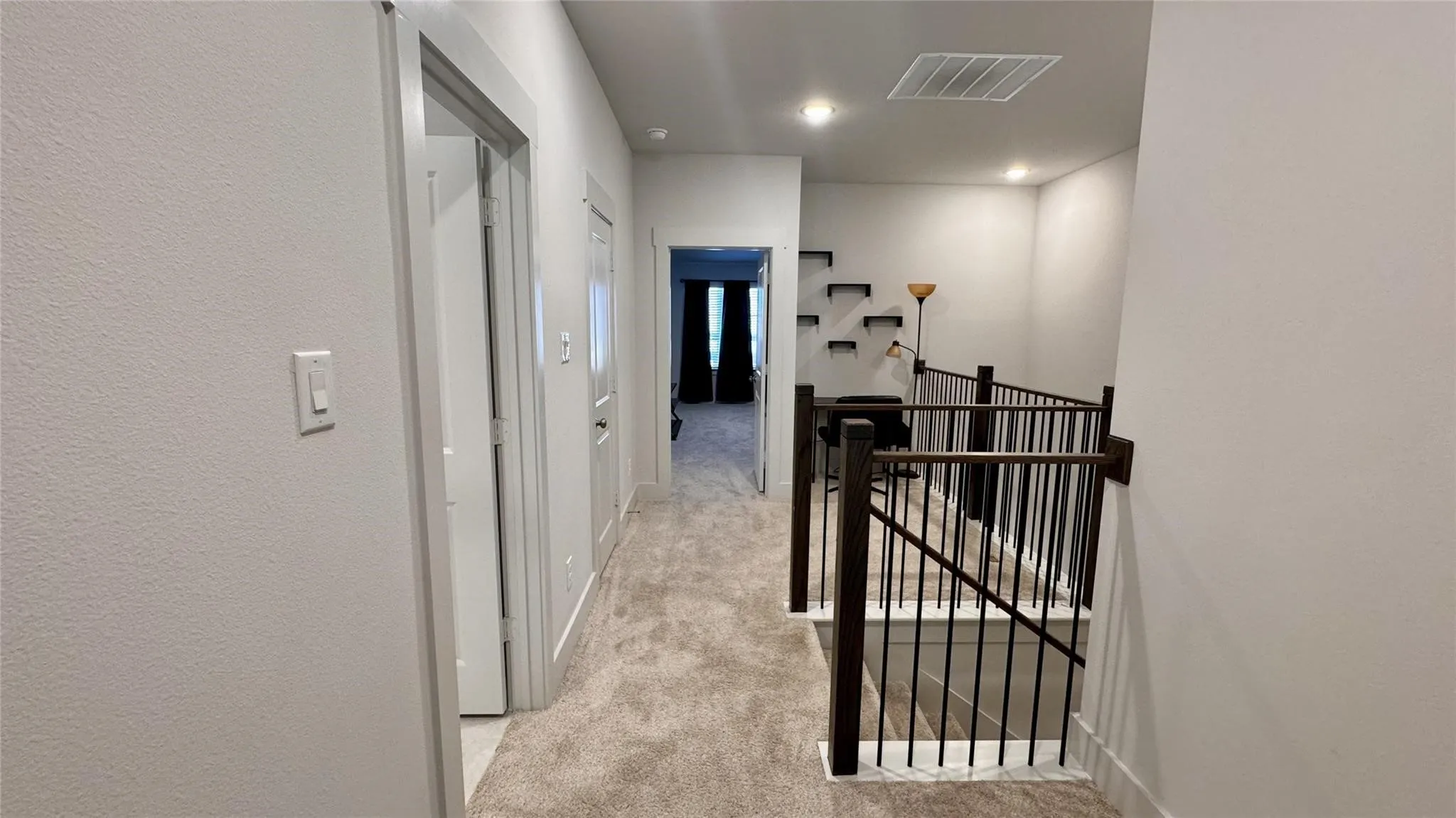 Upper level landing featuring light-toned carpeting and recessed lighting