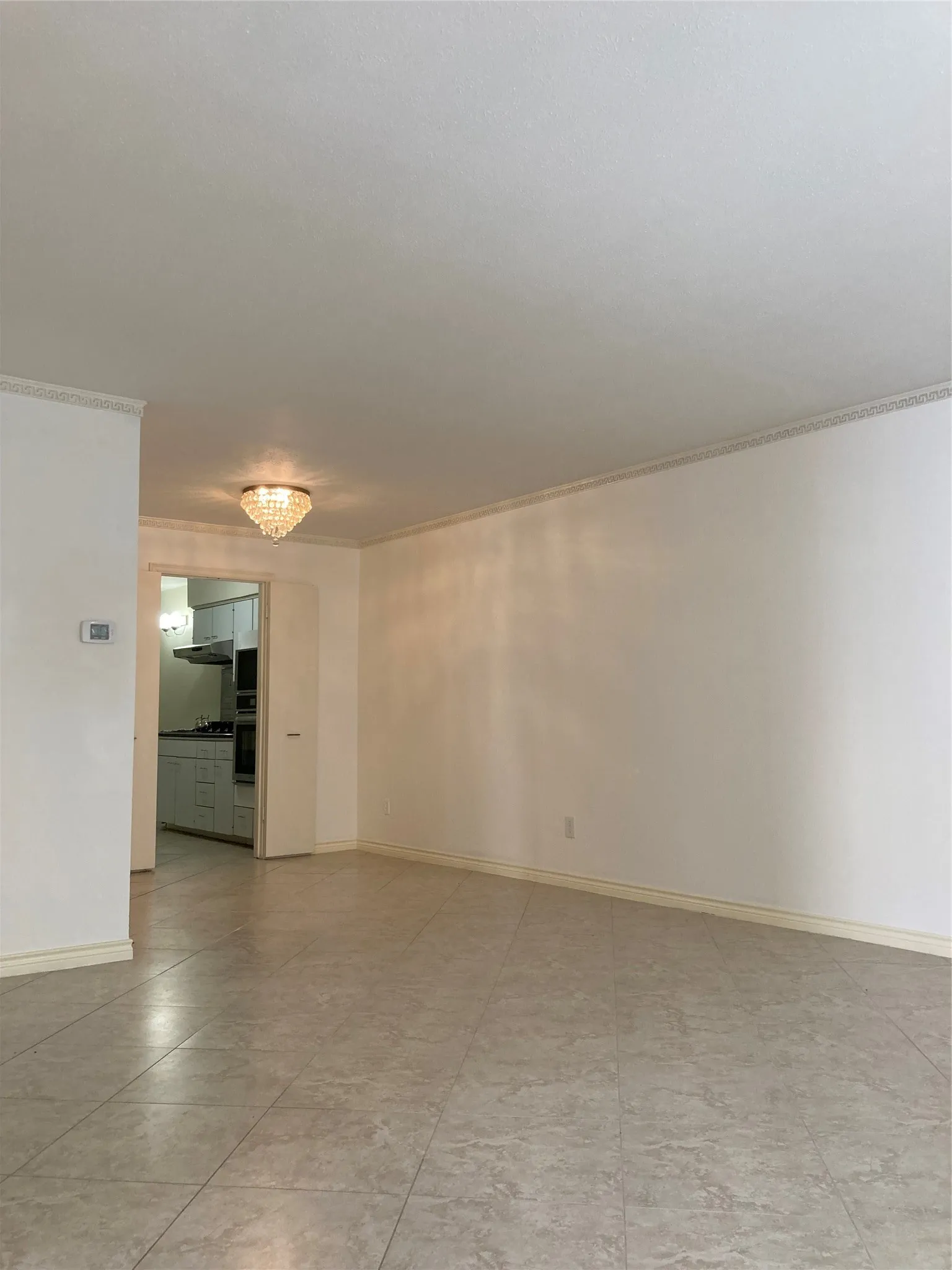 Tile floors and decorative lighting in living/dining flex area