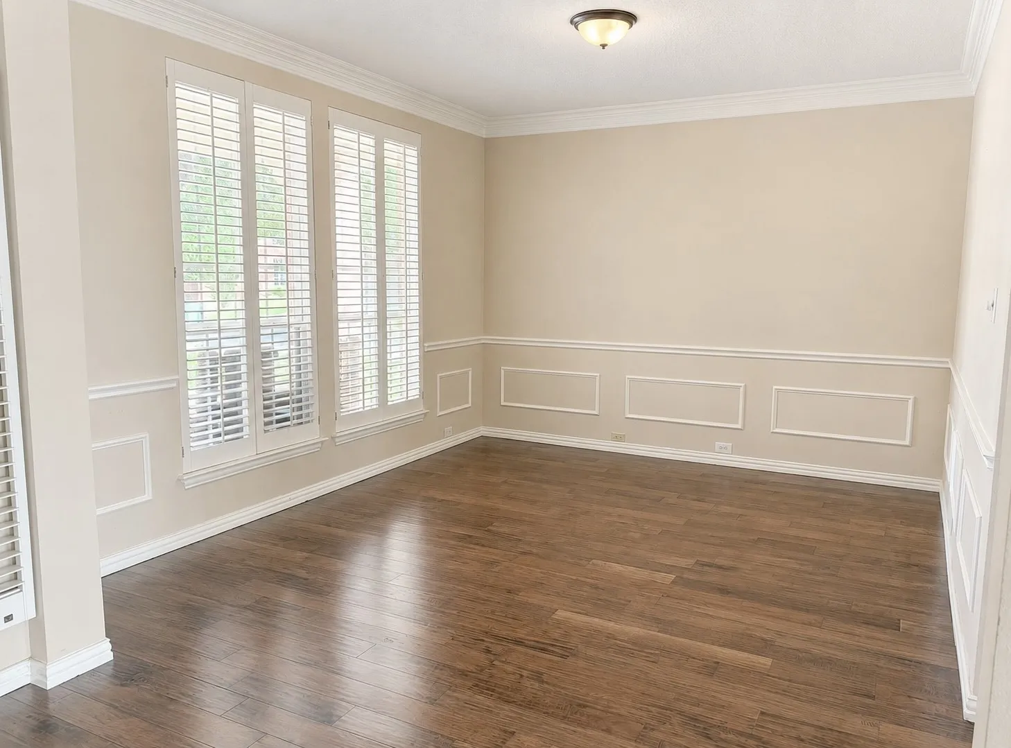 Hardwood-style flooring complemented by wainscoting and crown molding