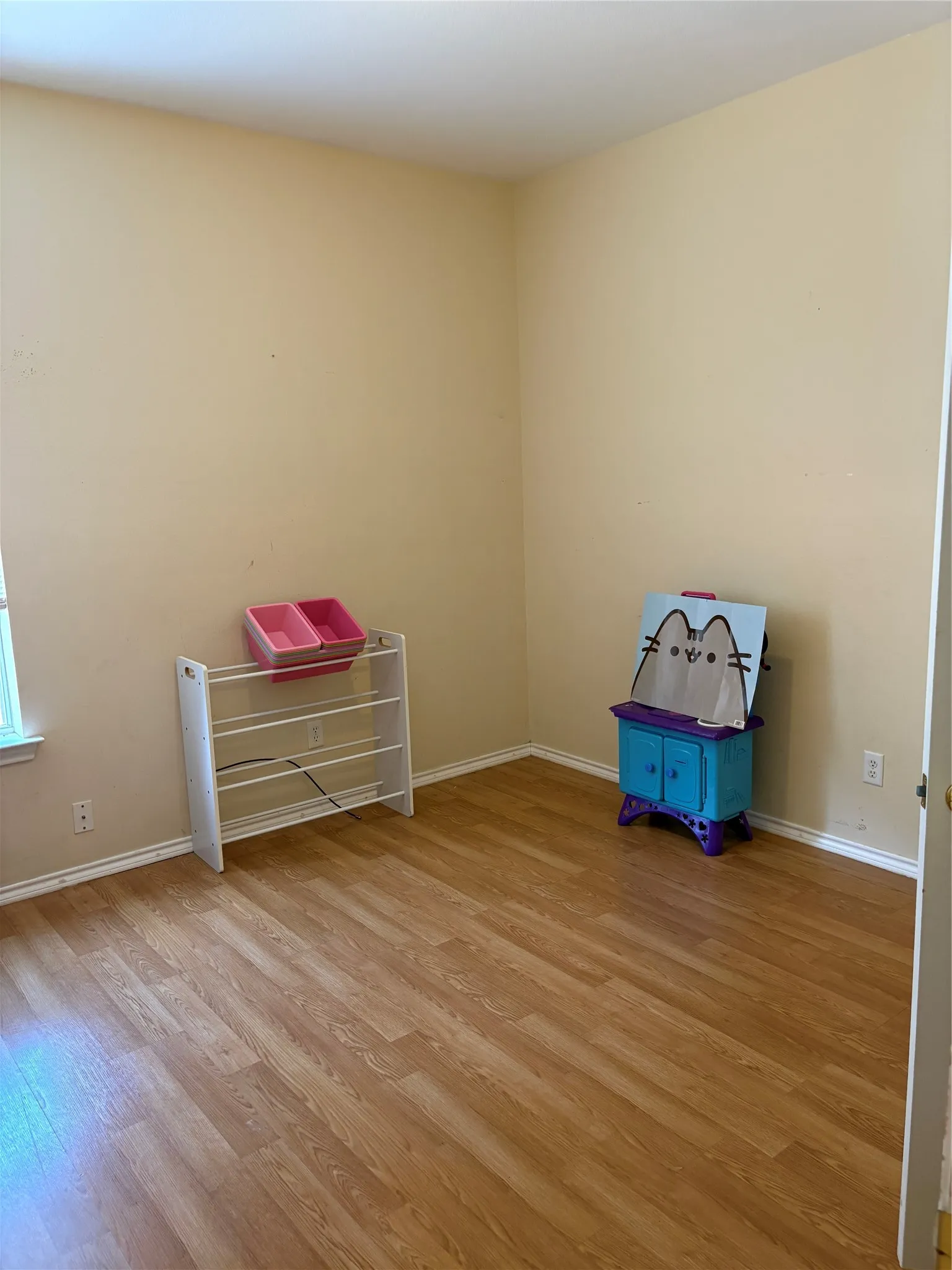 Wood-finish flooring with light-toned walls and white trim