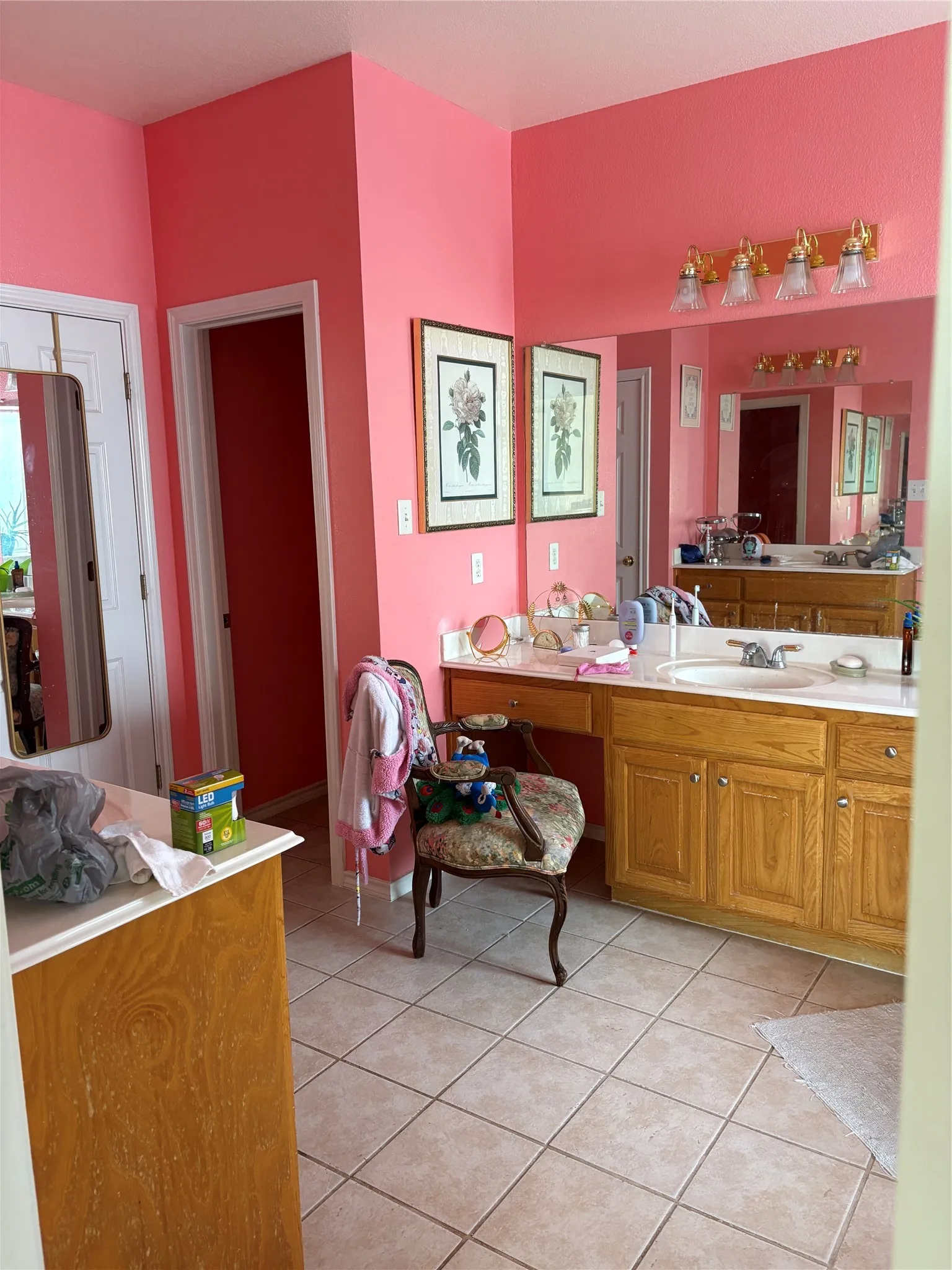 Dual vanity with wood-finish cabinetry, integrated sinks, and ample counter space