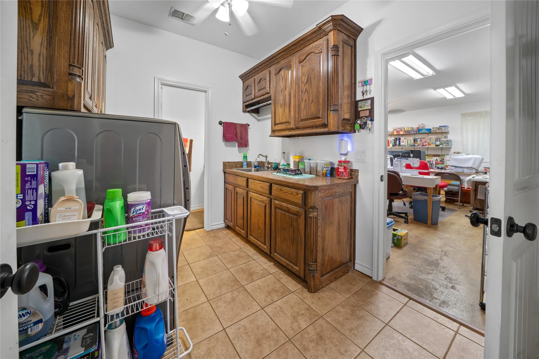 Laundry area with 1/2 bath leads from kitchen to bonus room