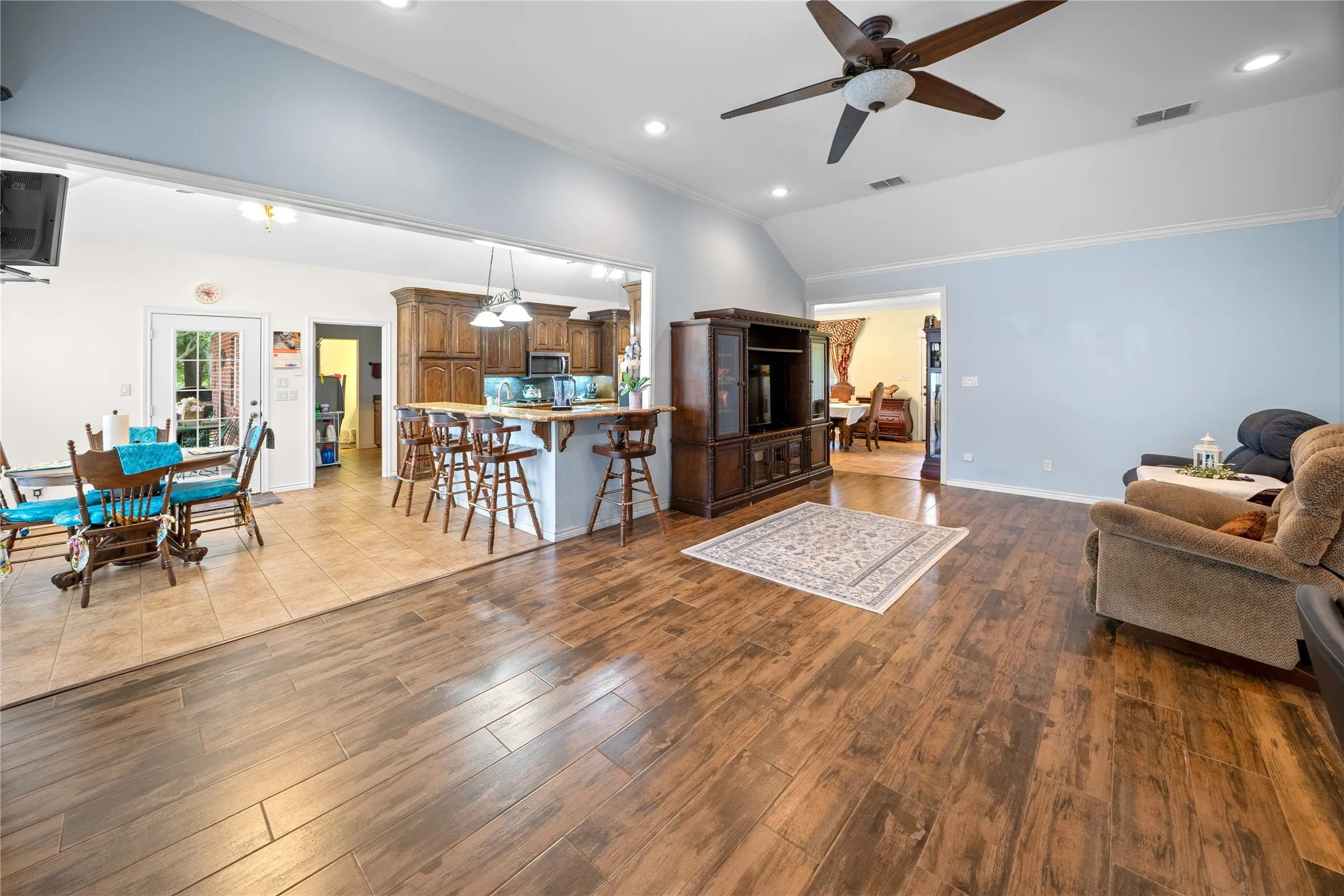 Living area flows to the breakfast area, to the kitchen, to the formal dining area and back to the living area