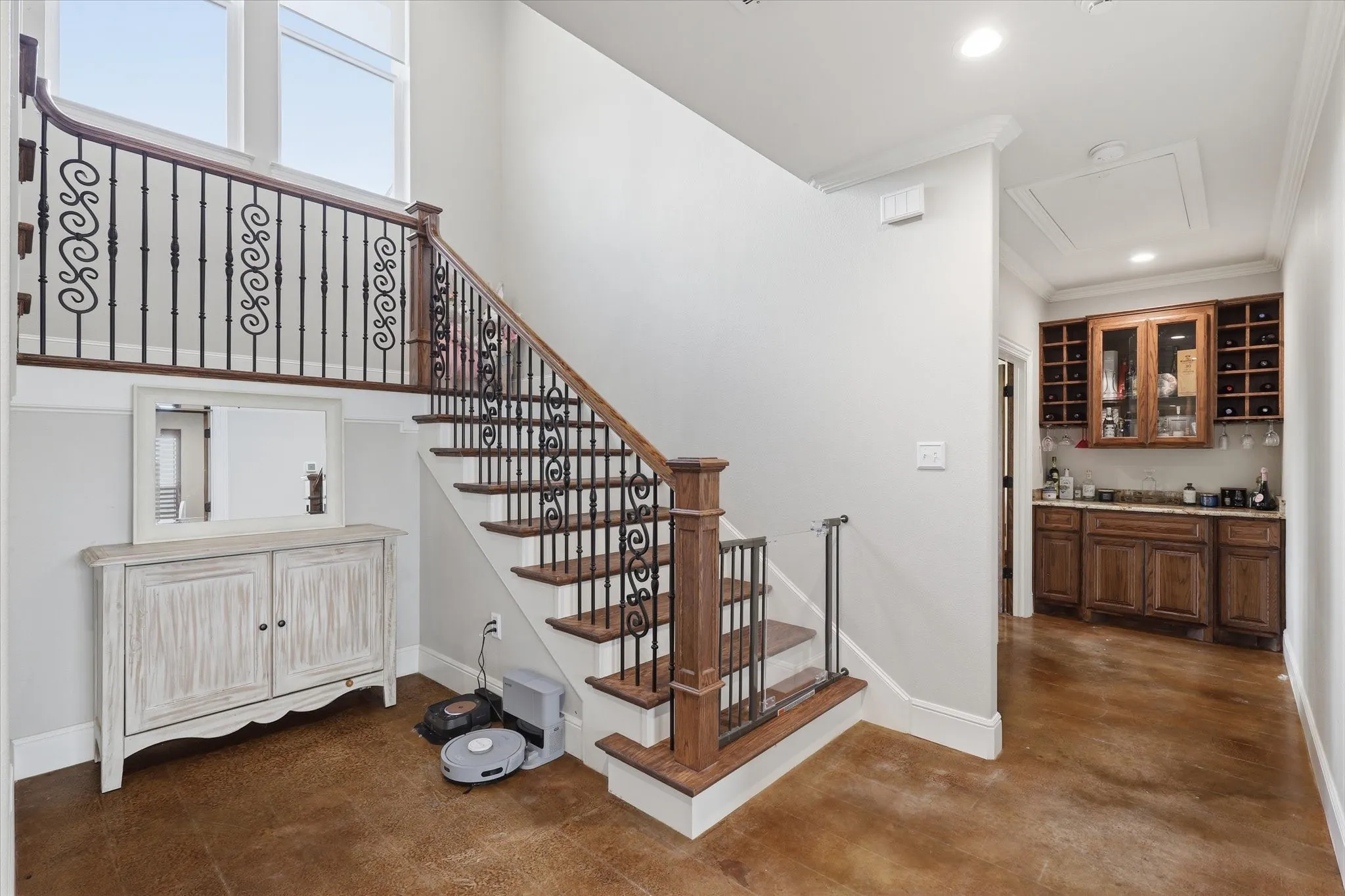 Staircase with wood treads and decorative wrought iron balusters