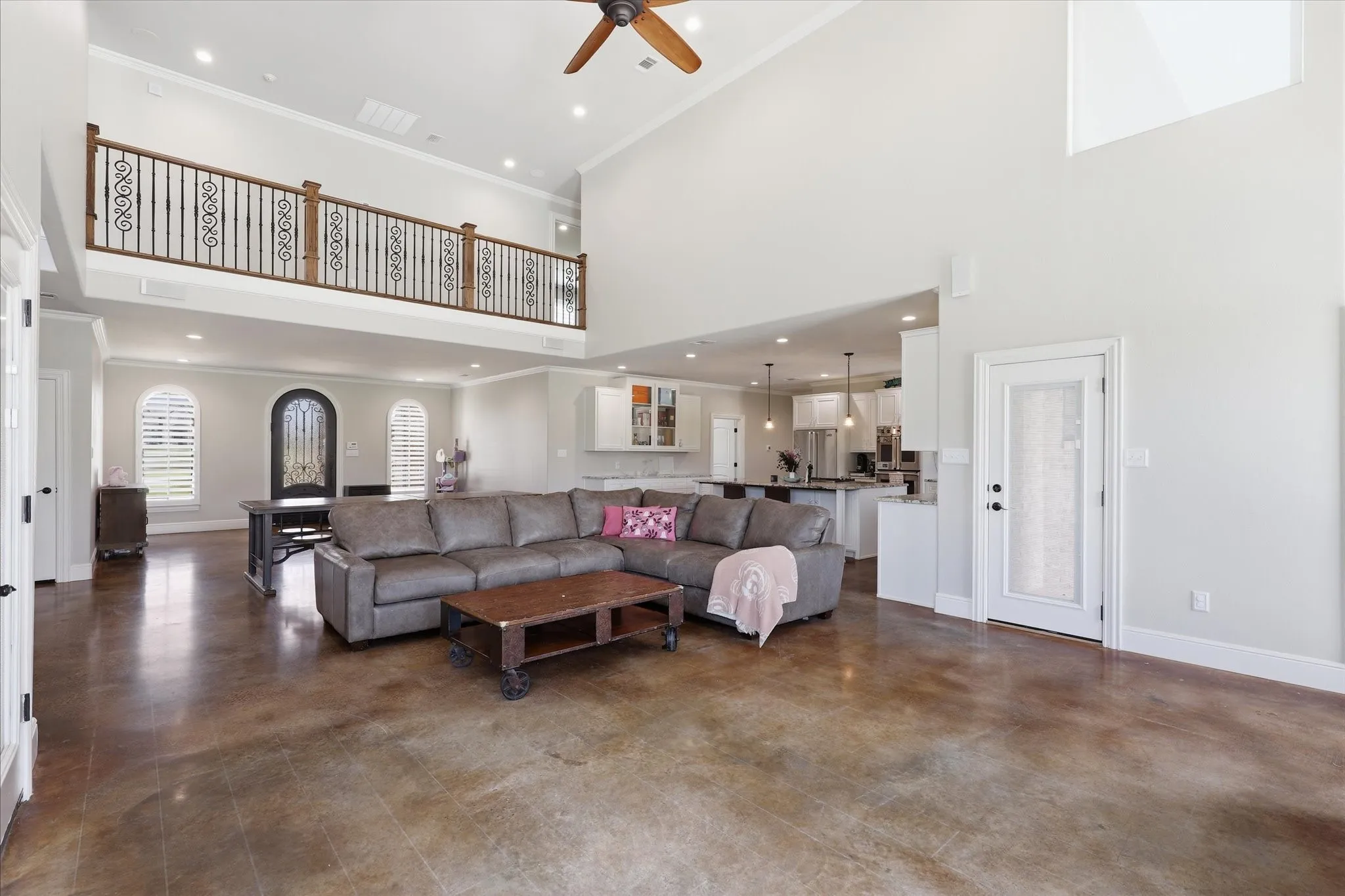 Expansive living area featuring soaring ceilings and wood-finish flooring