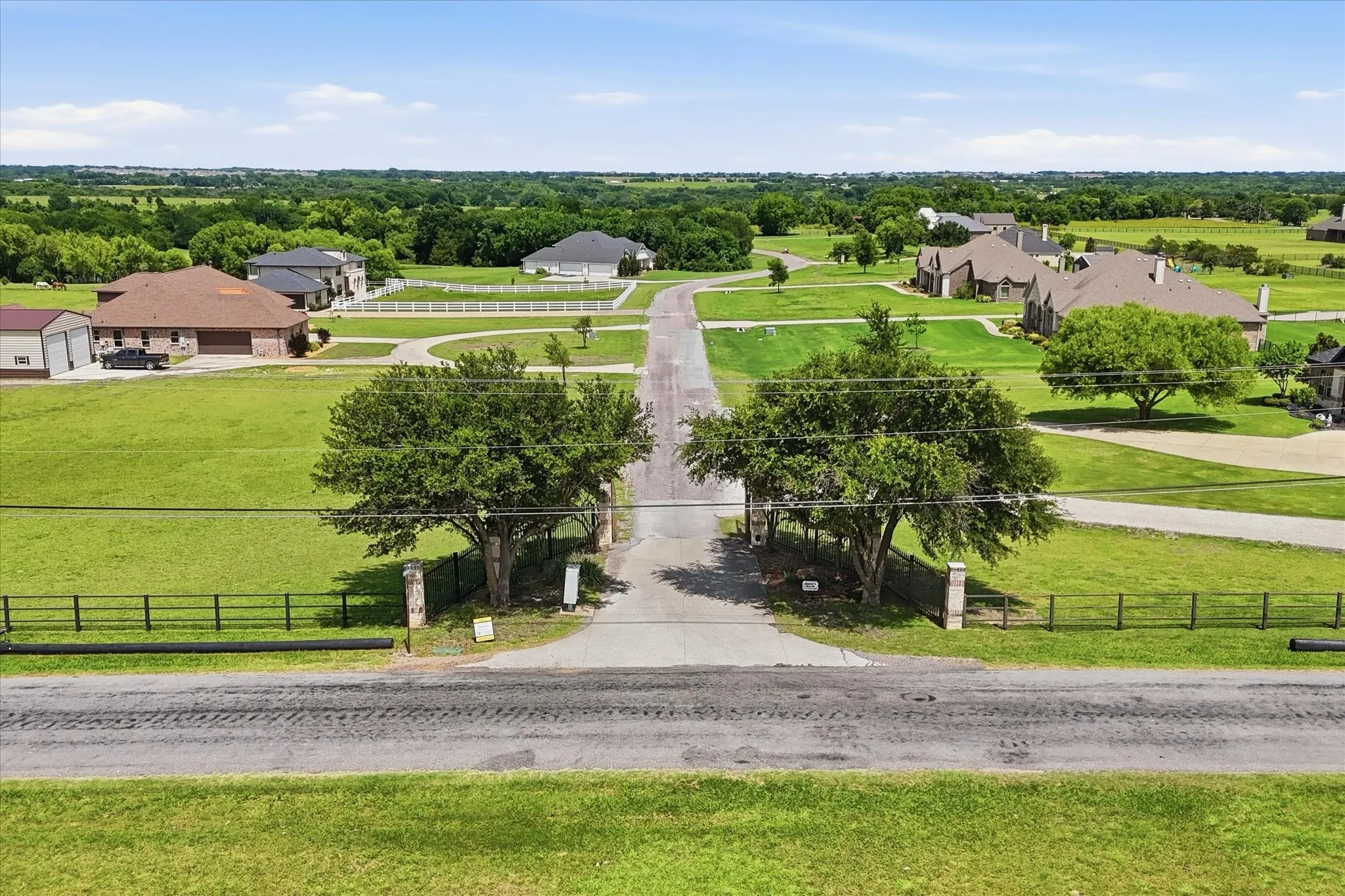 Gated entrance leading to private road.