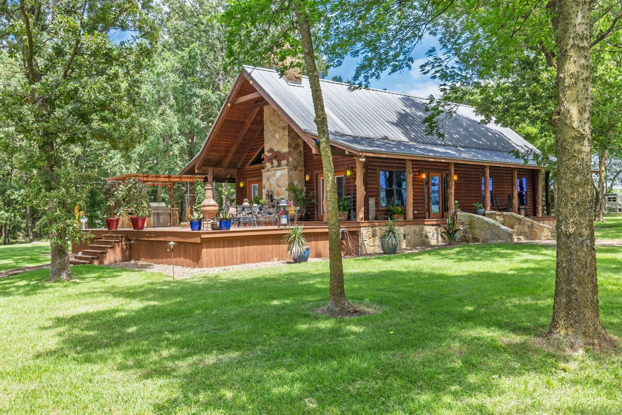 Custom log home is set remotely in the trees.