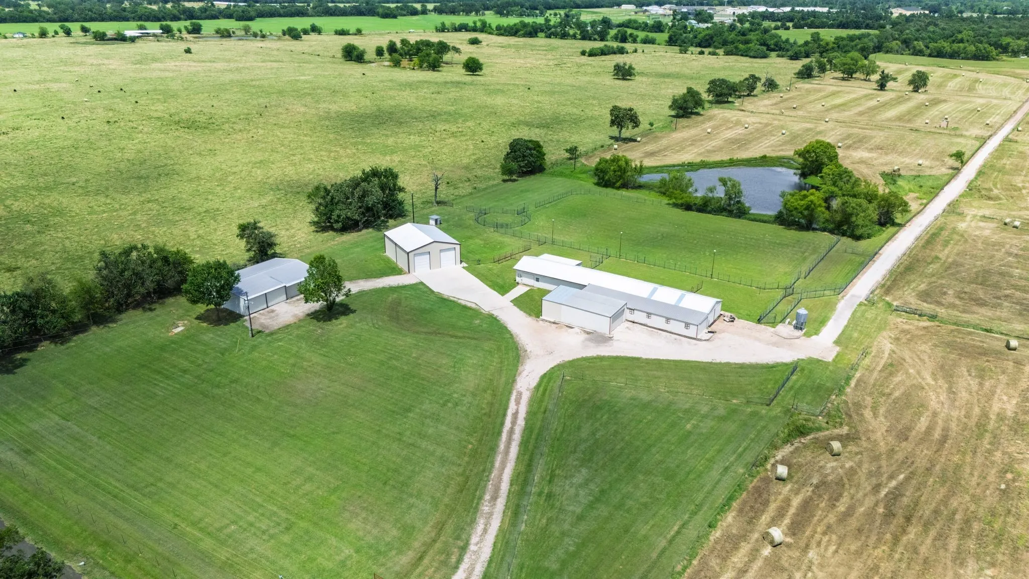 Multiple outbuildings, secure, gated entrance, arena.