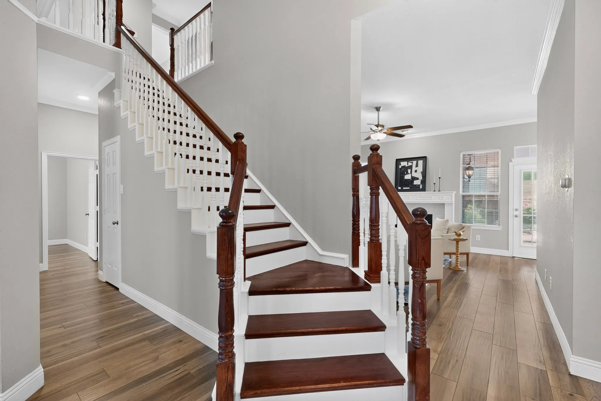 Hardwood staircase with white risers and dark wood treads