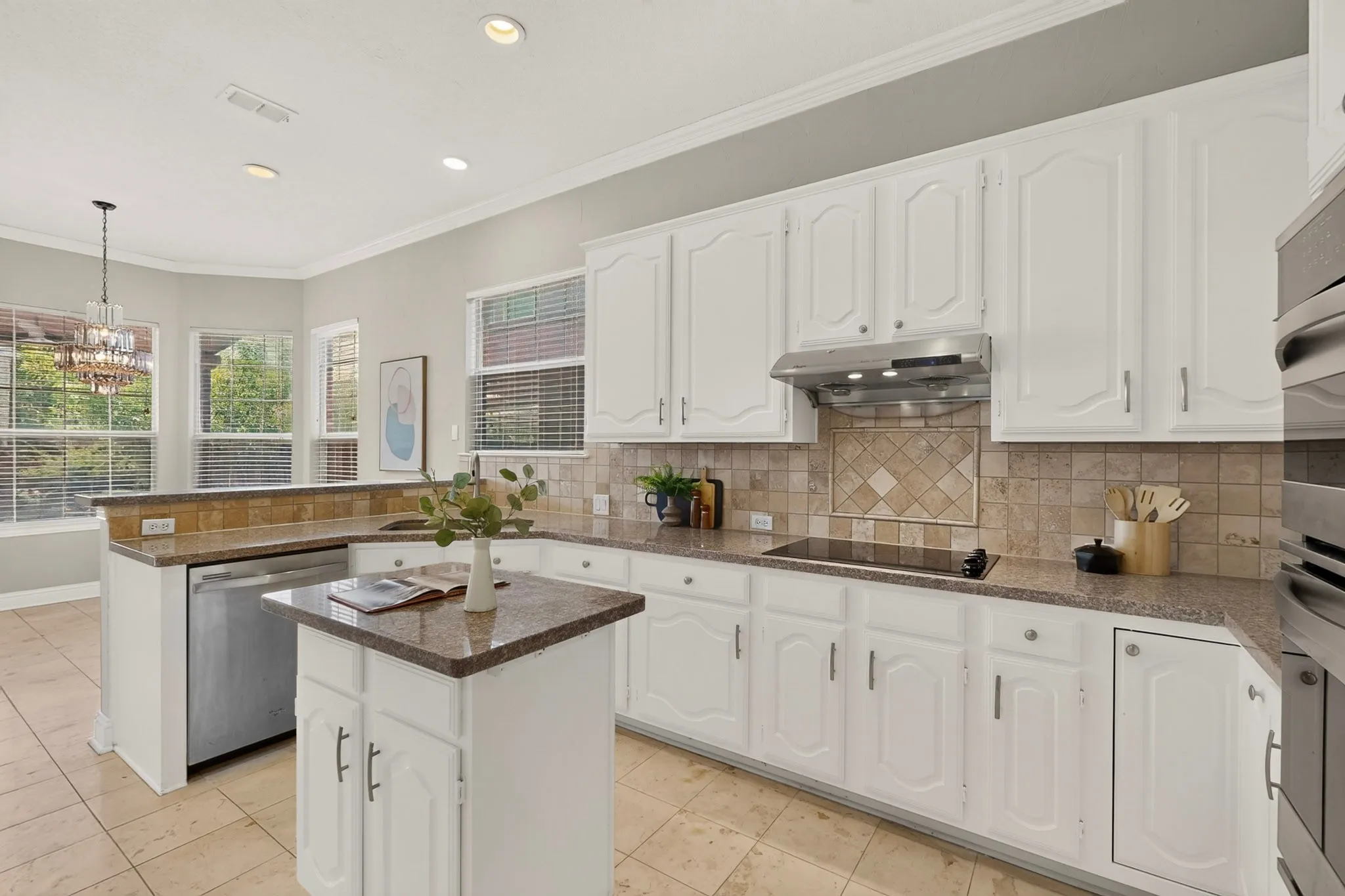 Kitchen featuring white cabinetry, stone-finish countertops, and a tiled backsplash