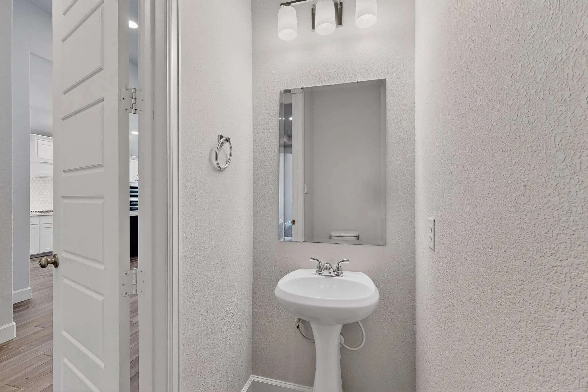 Half bath featuring wood finished floors