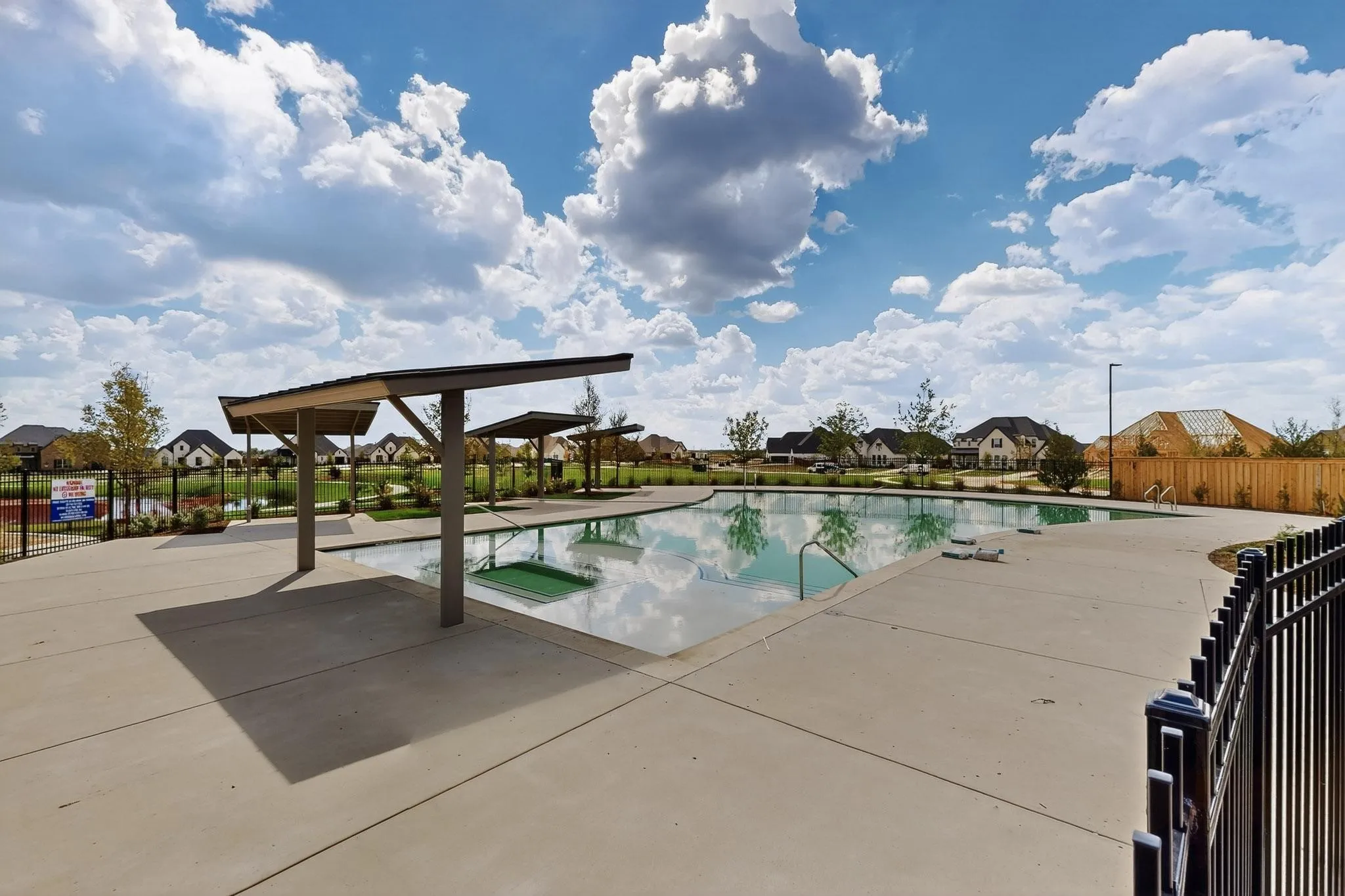 Community pool featuring a patio and a residential view