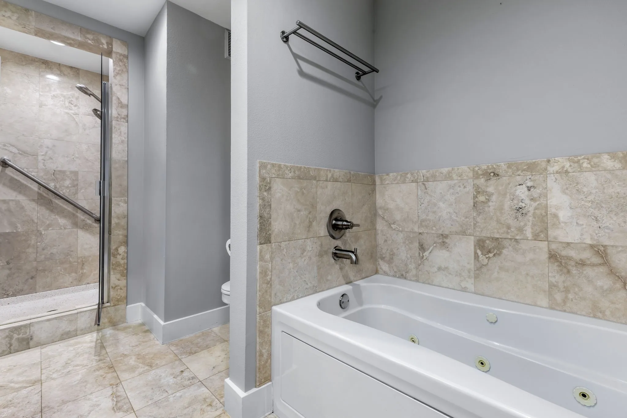 Jetted tub and a separate shower complete the luxurious primary bath.
