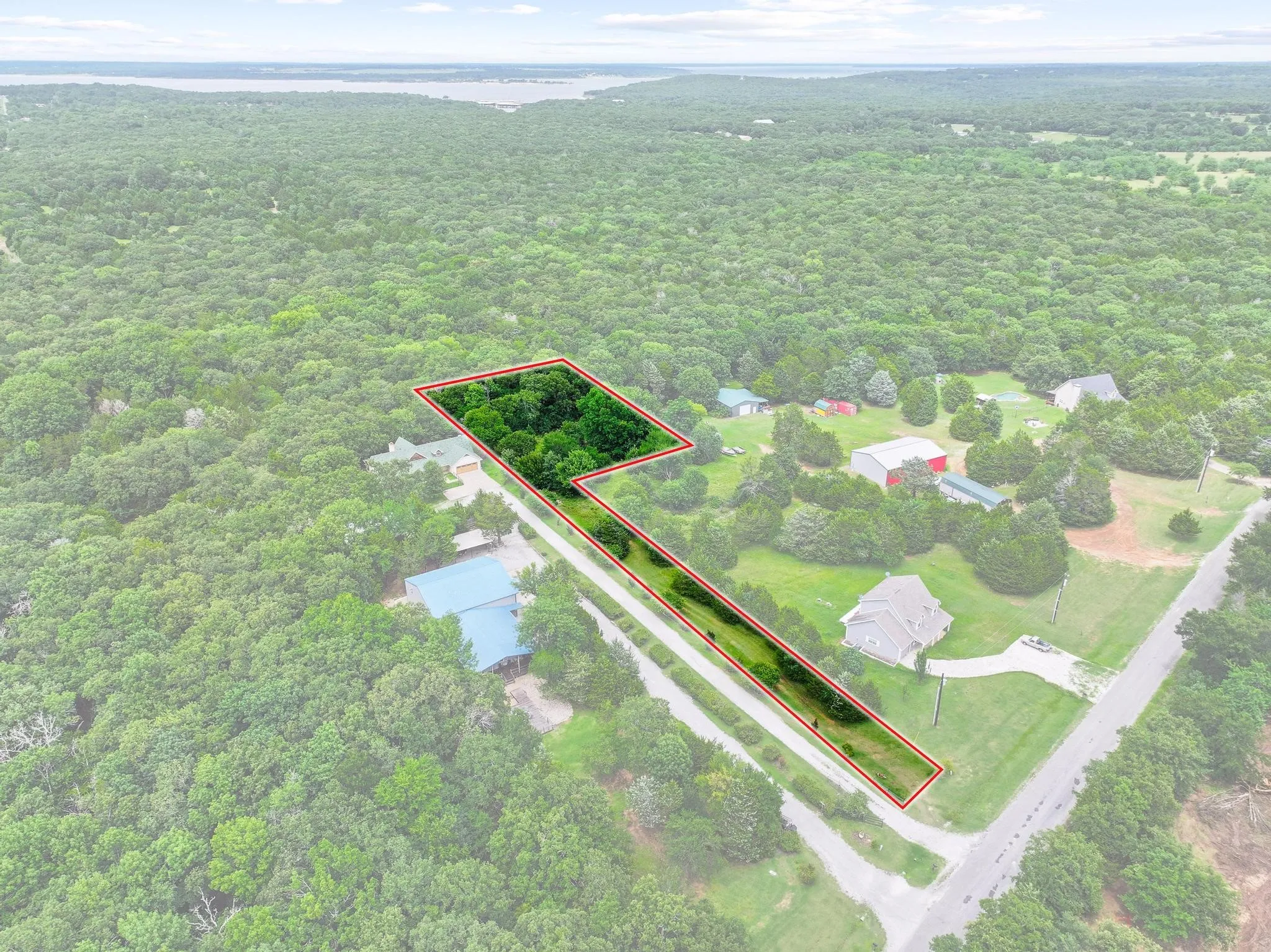Expansive wooded lot offering significant tree cover and open grassy areas