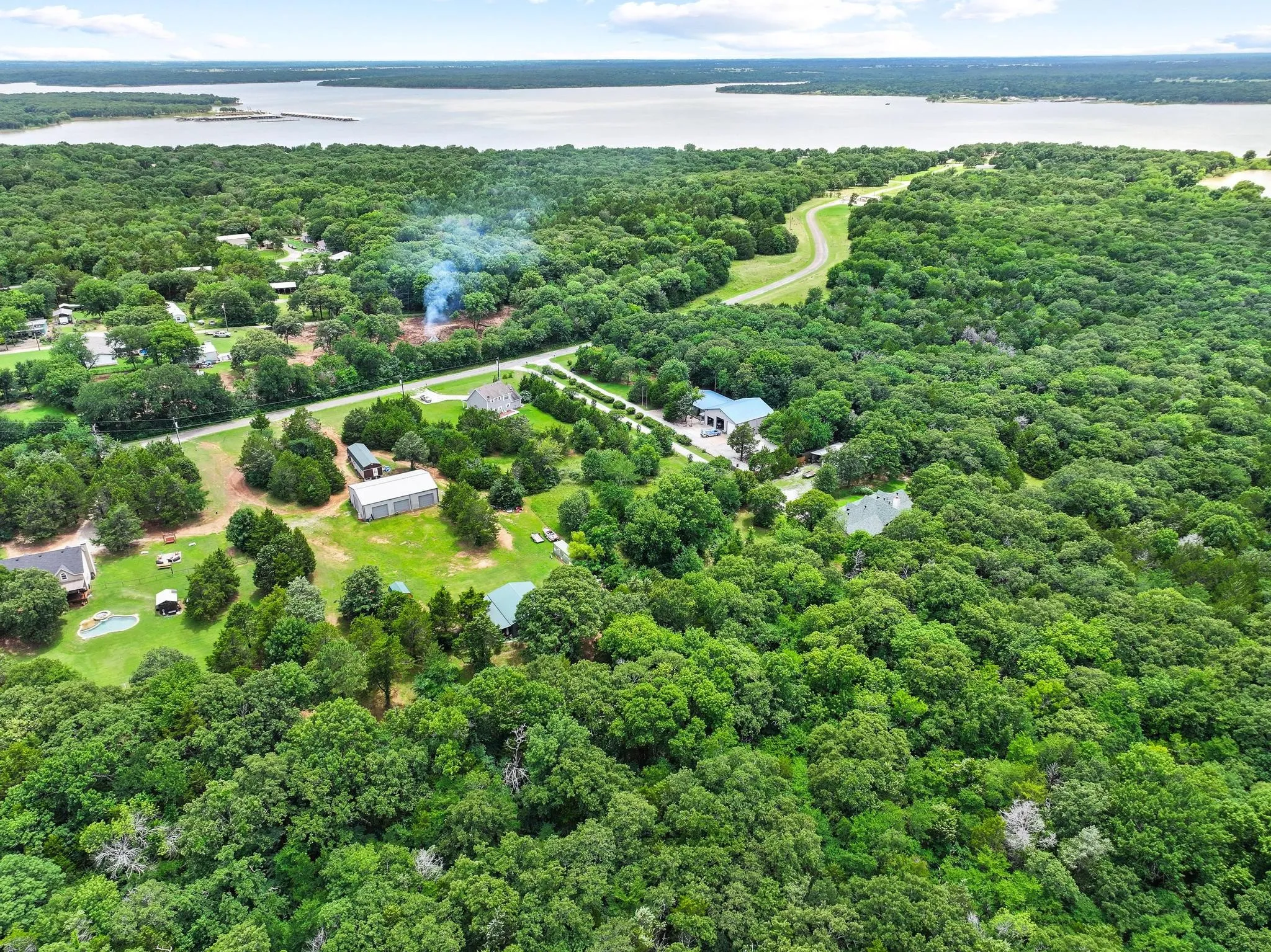 Expansive tree-covered landscape bordering a large body of water