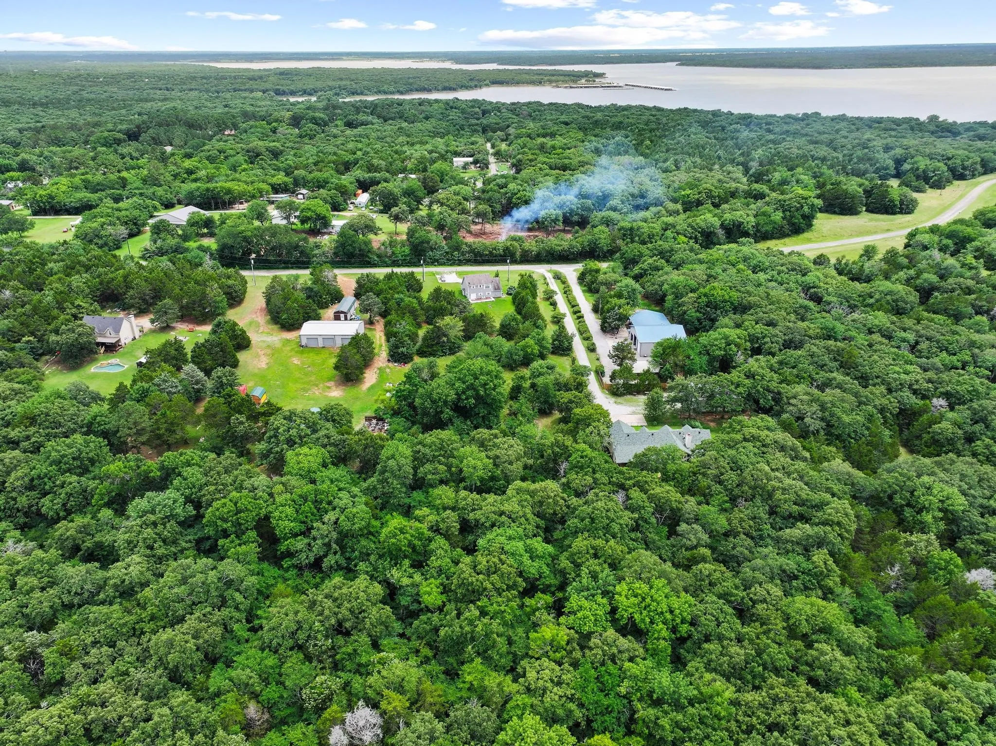 Expansive wooded property featuring a natural landscape and distant water body