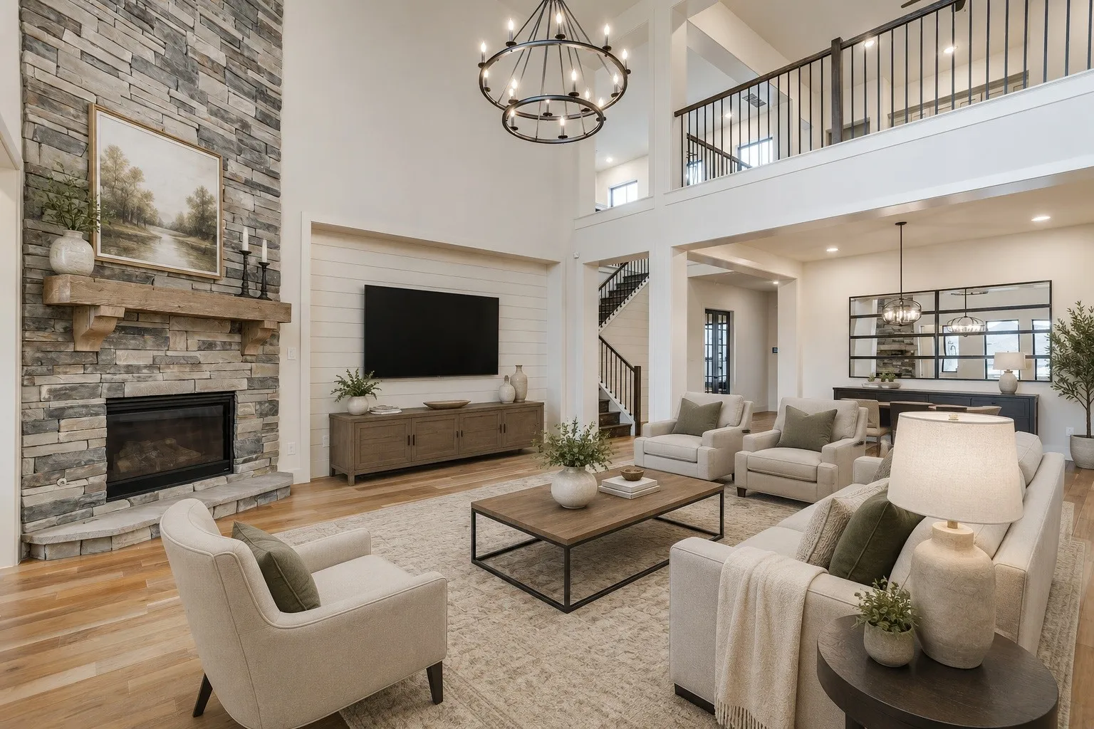 Spacious living area featuring a stacked stone fireplace with a substantial wood mantel, a two-story ceiling, and wood-finish flooring. * Photo is virtually staged using AI.