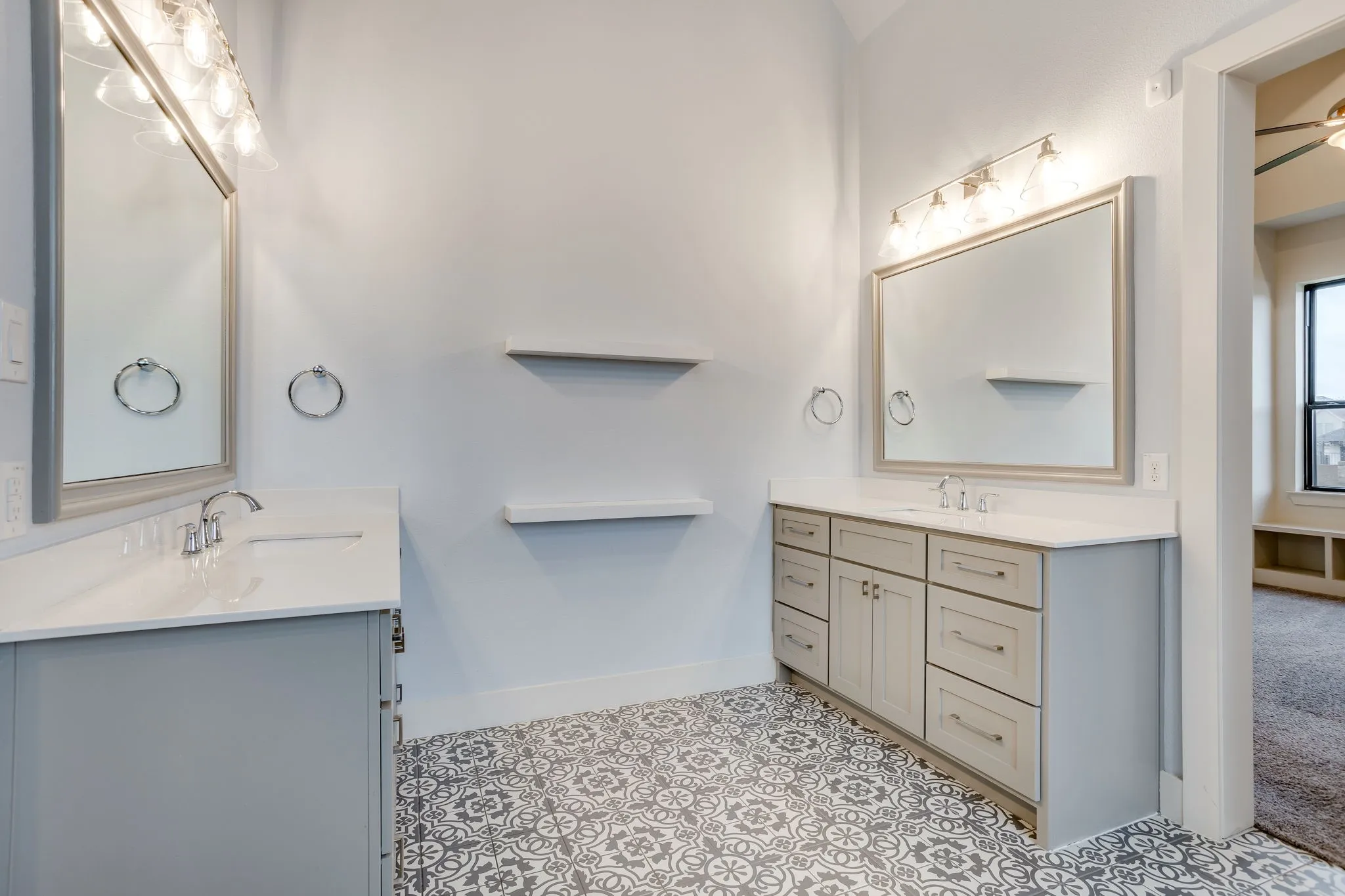 Bathroom featuring dual vanities with light gray cabinetry and white countertops