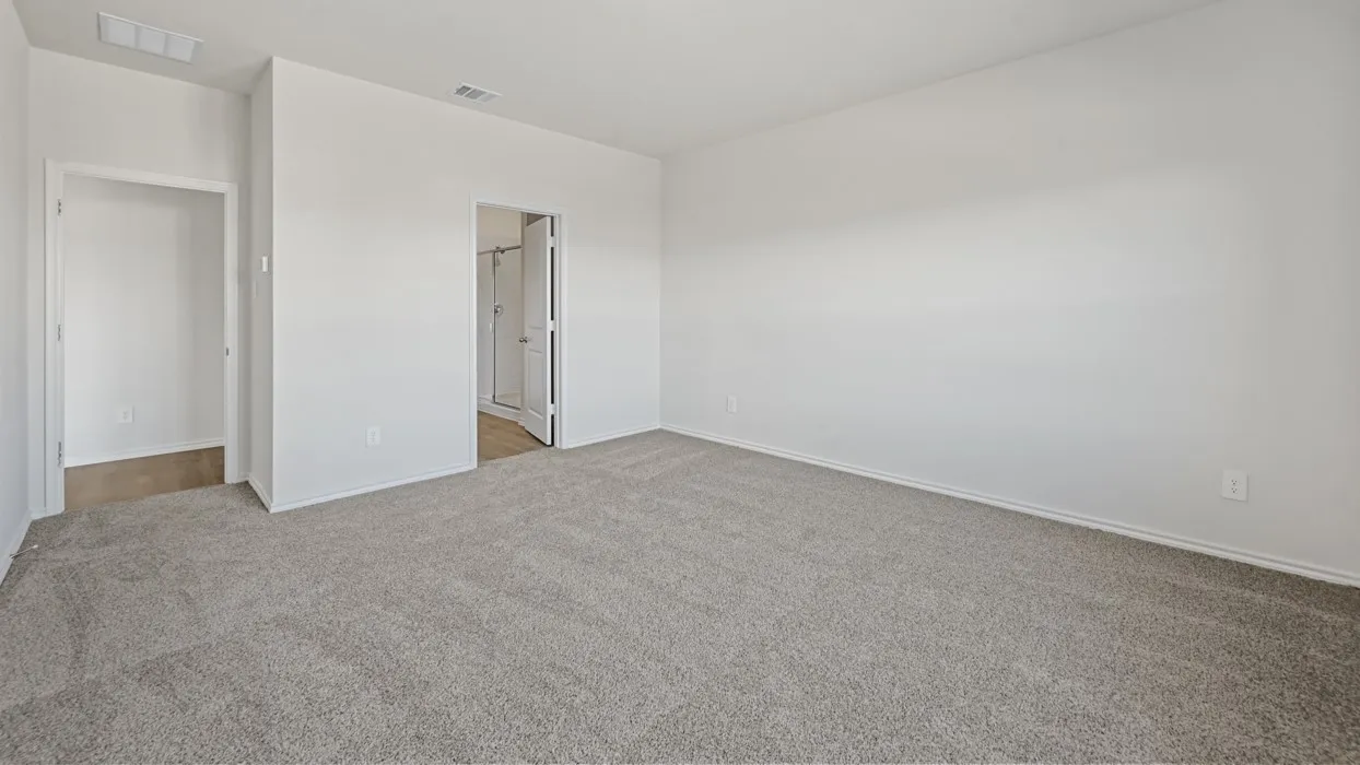 Spacious room featuring neutral carpeting, white walls, and white trim