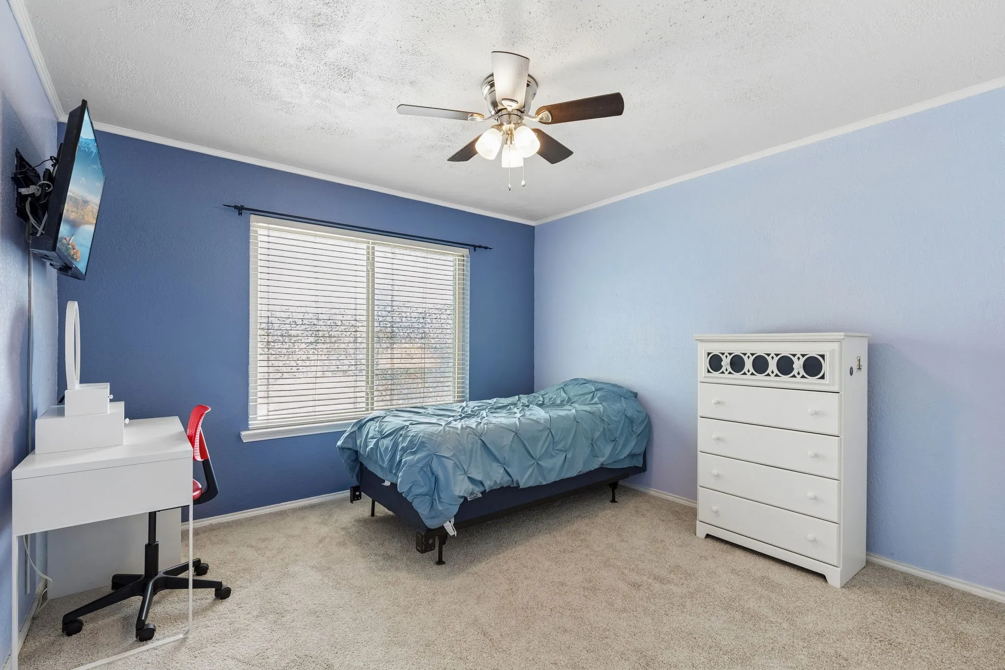 Bedroom with light colored carpet, a ceiling fan, a textured ceiling, and ornamental molding