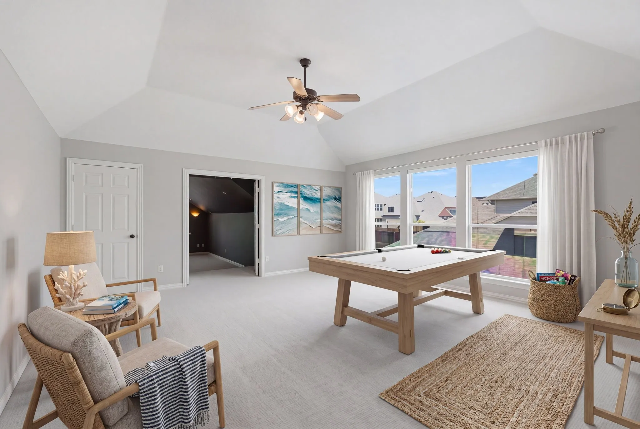 This spacious and inviting game room serves as an ideal multifunctional space, featuring a private entry door for easy accessibility and a large wall of windows that floods the area with natural light. The room is thoughtfully designed with an integrated storage closet to keep belongings organized and out of sight. It provides seamless, convenient access to the adjoining media room through double doors, while a separate hallway leads directly to a private secondary bedroom and a fully equipped bathroom, making this an excellent layout for guests or a dedicated entertainment suite. virtually staged