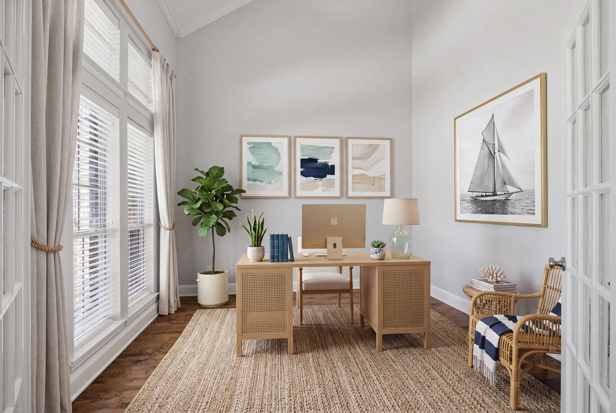 This home office space boasts a stunning aesthetic highlighted by a double row of windows that flood the room with abundant natural light. The room features impressive vaulted ceilings that create an airy, spacious atmosphere, complemented by elegant crown molding that adds a touch of sophisticated character. The entire area is finished with high-quality, polished hardwood floors, offering both a warm, inviting tone and a timeless, professional appeal perfect for any work environment. virtually staged