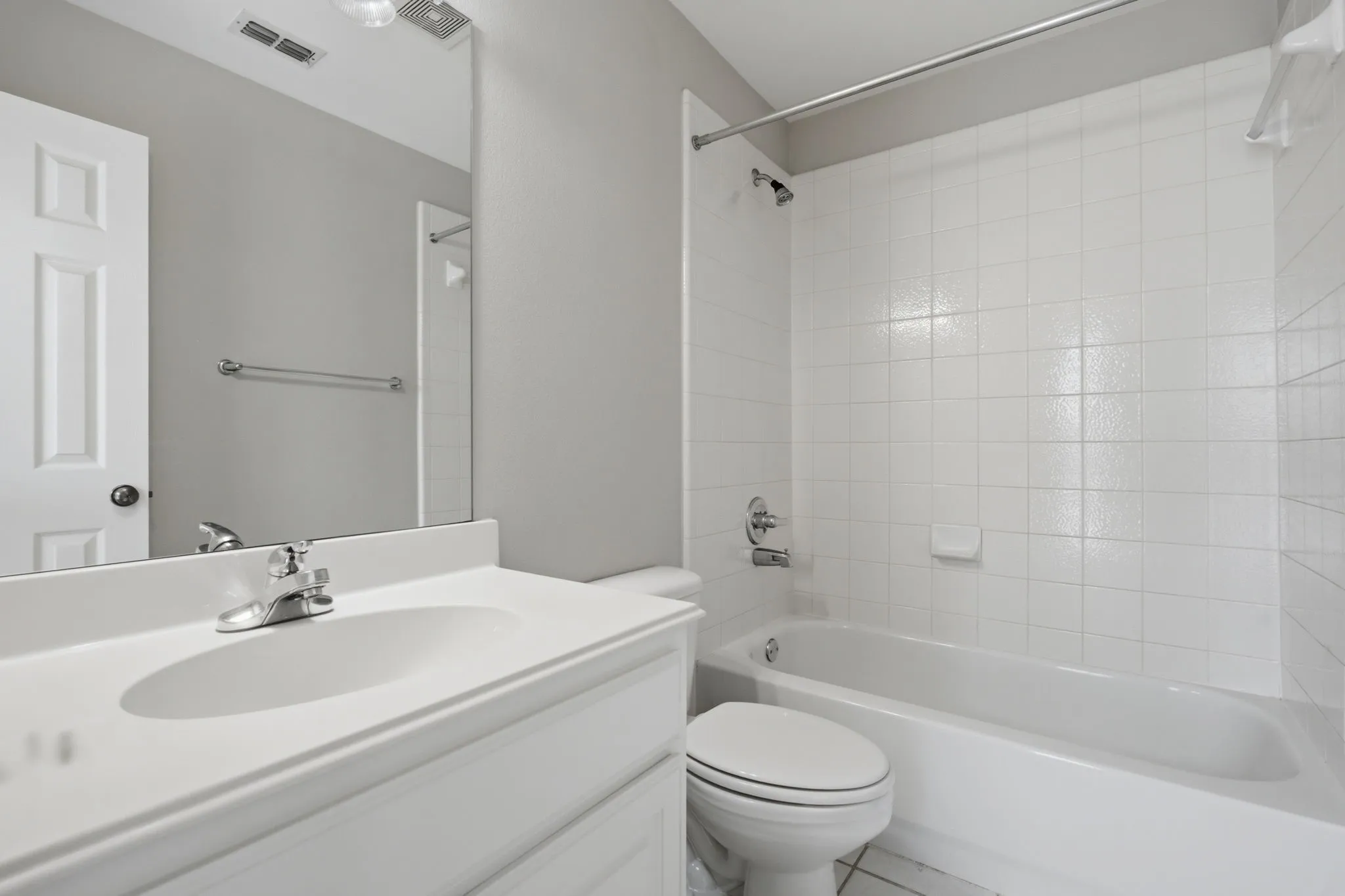 This full bathroom is conveniently located just off the spacious game room area and is positioned directly adjacent to the secondary bedroom, providing easy access for both guests and residents.