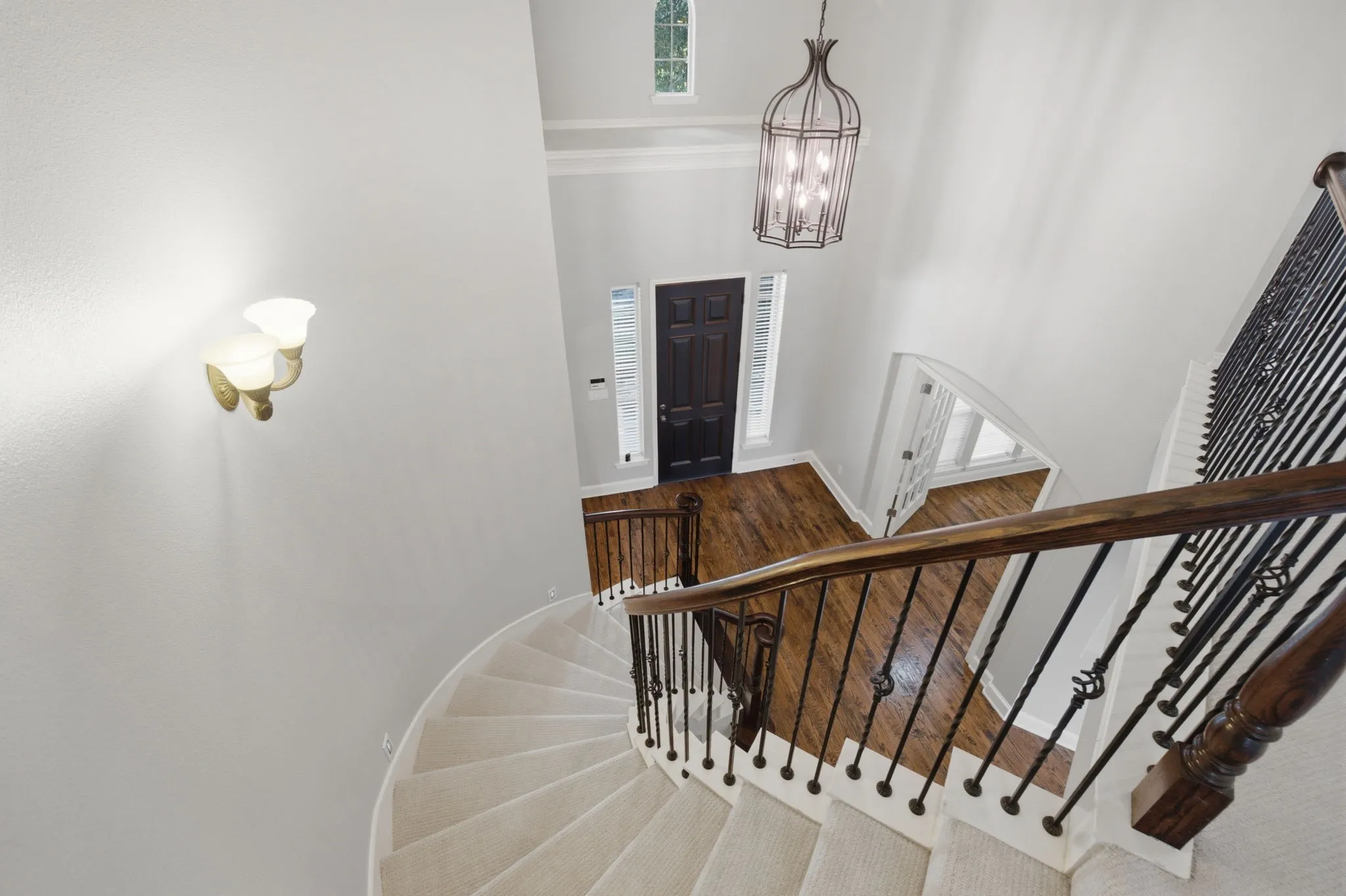 This image showcases the grand staircase, offering a clear and inviting perspective that looks directly down into the beautifully appointed entry foyer below, highlighting the architectural flow of the home.