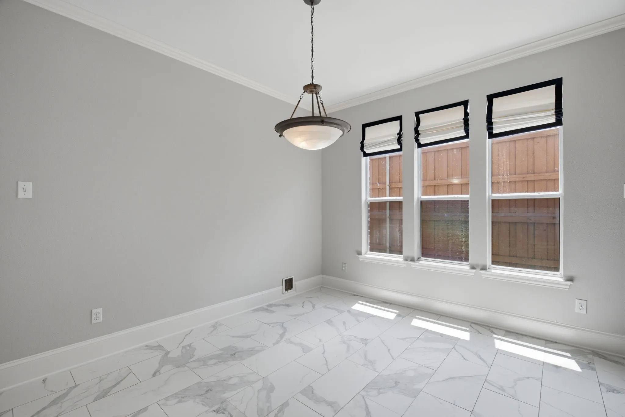 The breakfast nook is bright and inviting, featuring three large, evenly spaced windows that allow for an abundance of natural light to flood the space. For added functionality and comfort, each of these windows is equipped with high-quality, adjustable fabric privacy shades that allow you to easily control the amount of light and seclusion throughout the day.