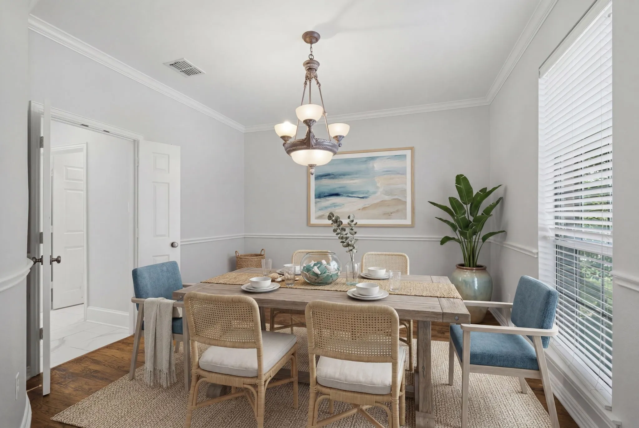 This bright and elegant dining room features ample space for hosting dinner parties, complete with large windows that provide an abundance of natural light and a seamless flow into the rest of the home's open floor plan. virtually staged