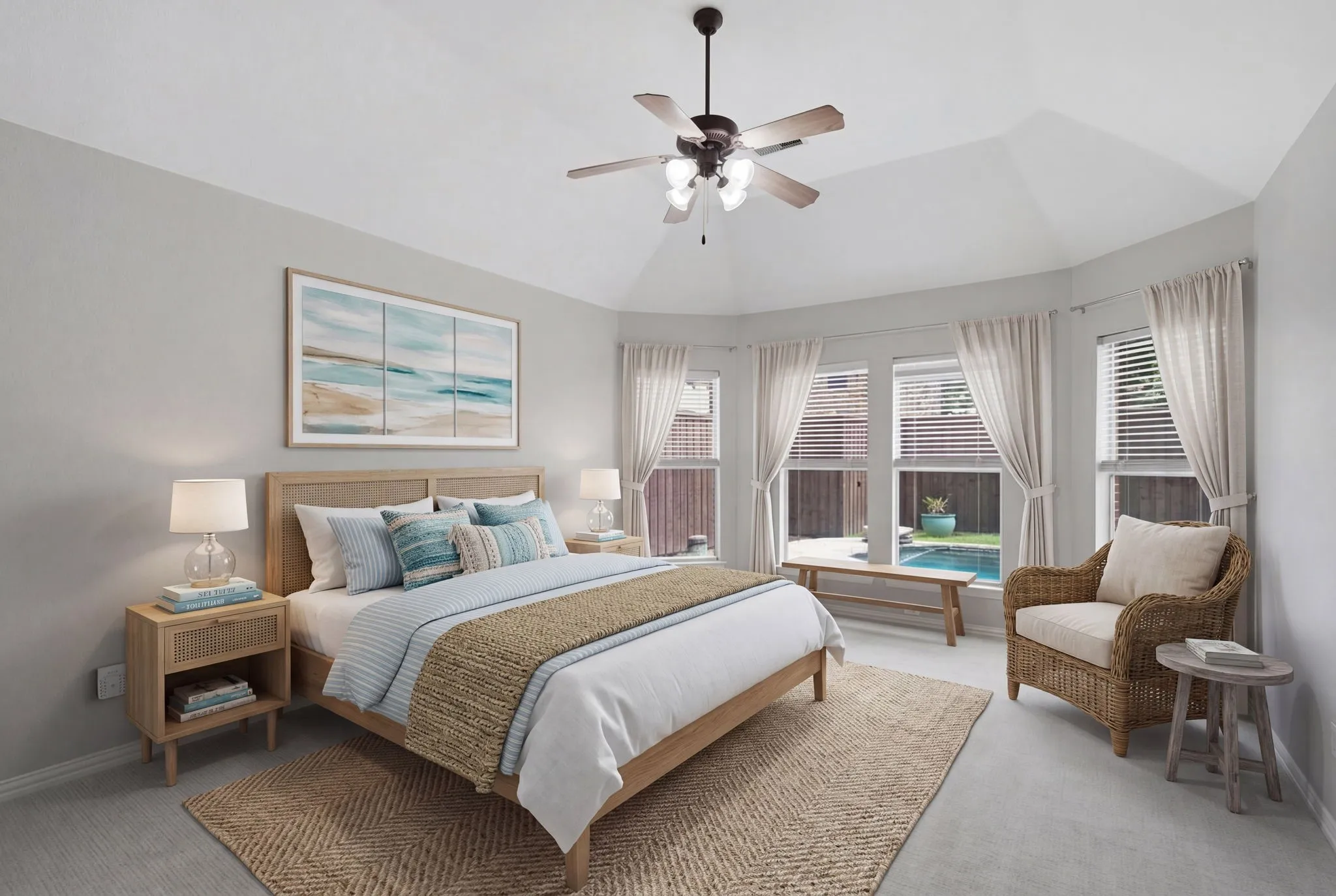 This spacious and inviting primary bedroom features a ceiling fan, a beautiful, light-filled bay window, and a comfortable dedicated sitting area that offers a relaxing, scenic view overlooking the backyard swimming pool. (Virtually staged)