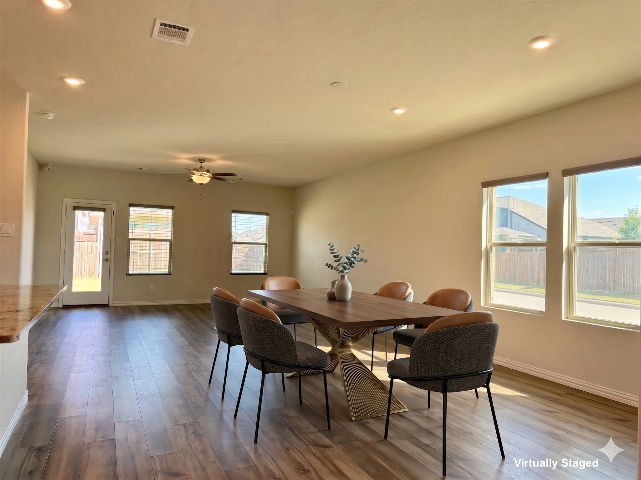 Open-concept living area featuring wood-finish flooring, recessed lighting, and a ceiling fan