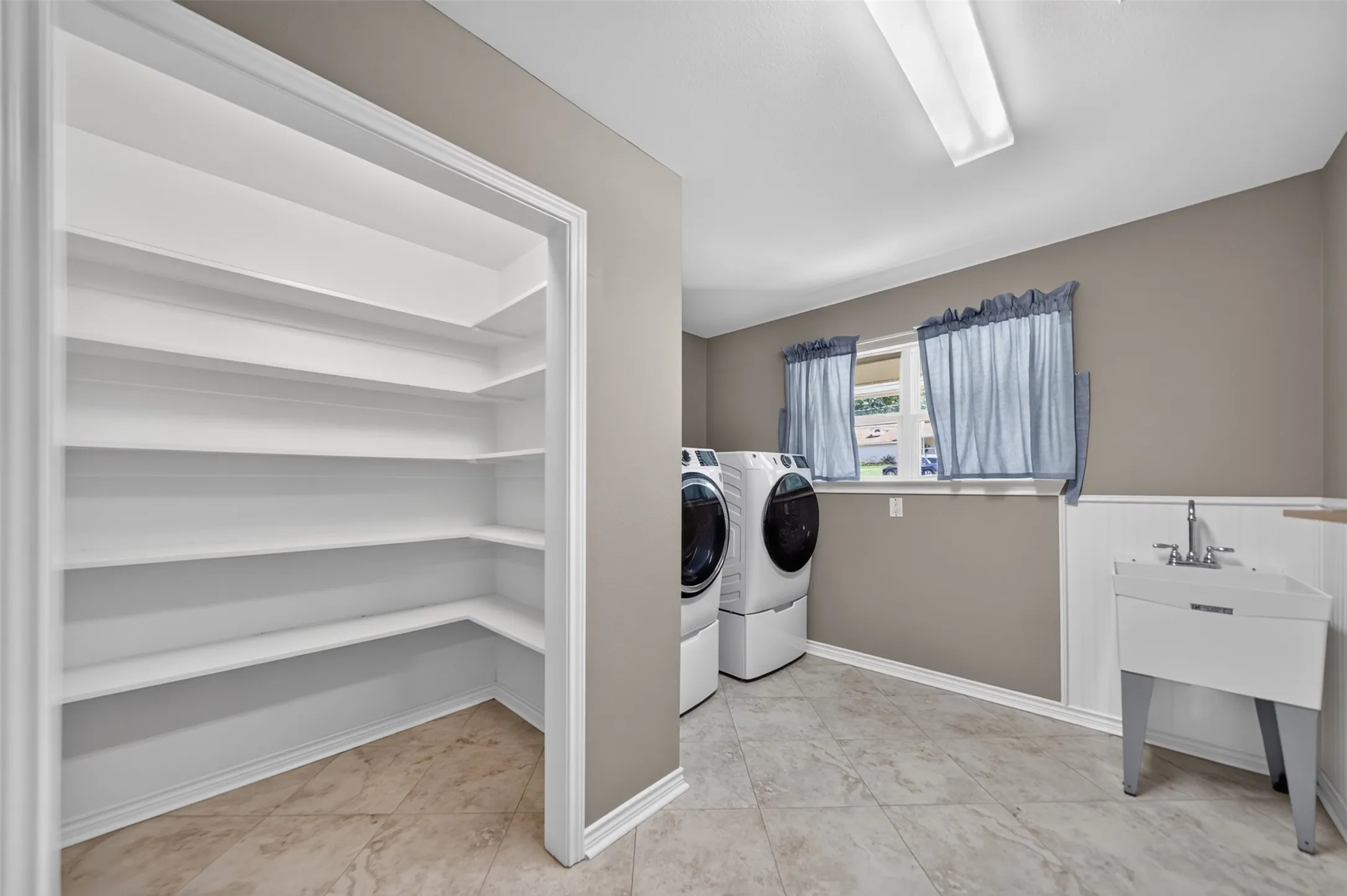 With large walk in pantry, utility sink and room for freezer