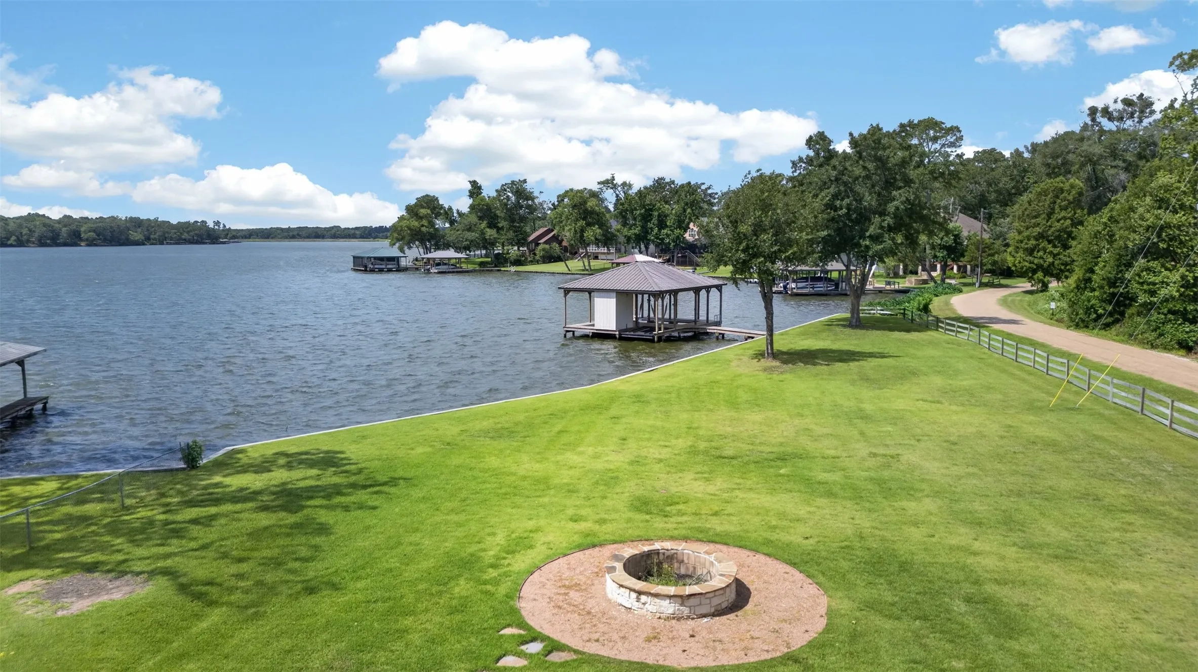 Fire Pit and view of boathouse and dock.