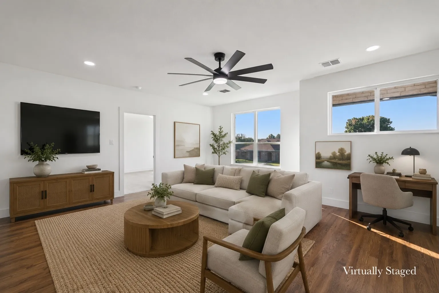 Spacious living area featuring wood-finish flooring, recessed lighting, and a modern ceiling fan